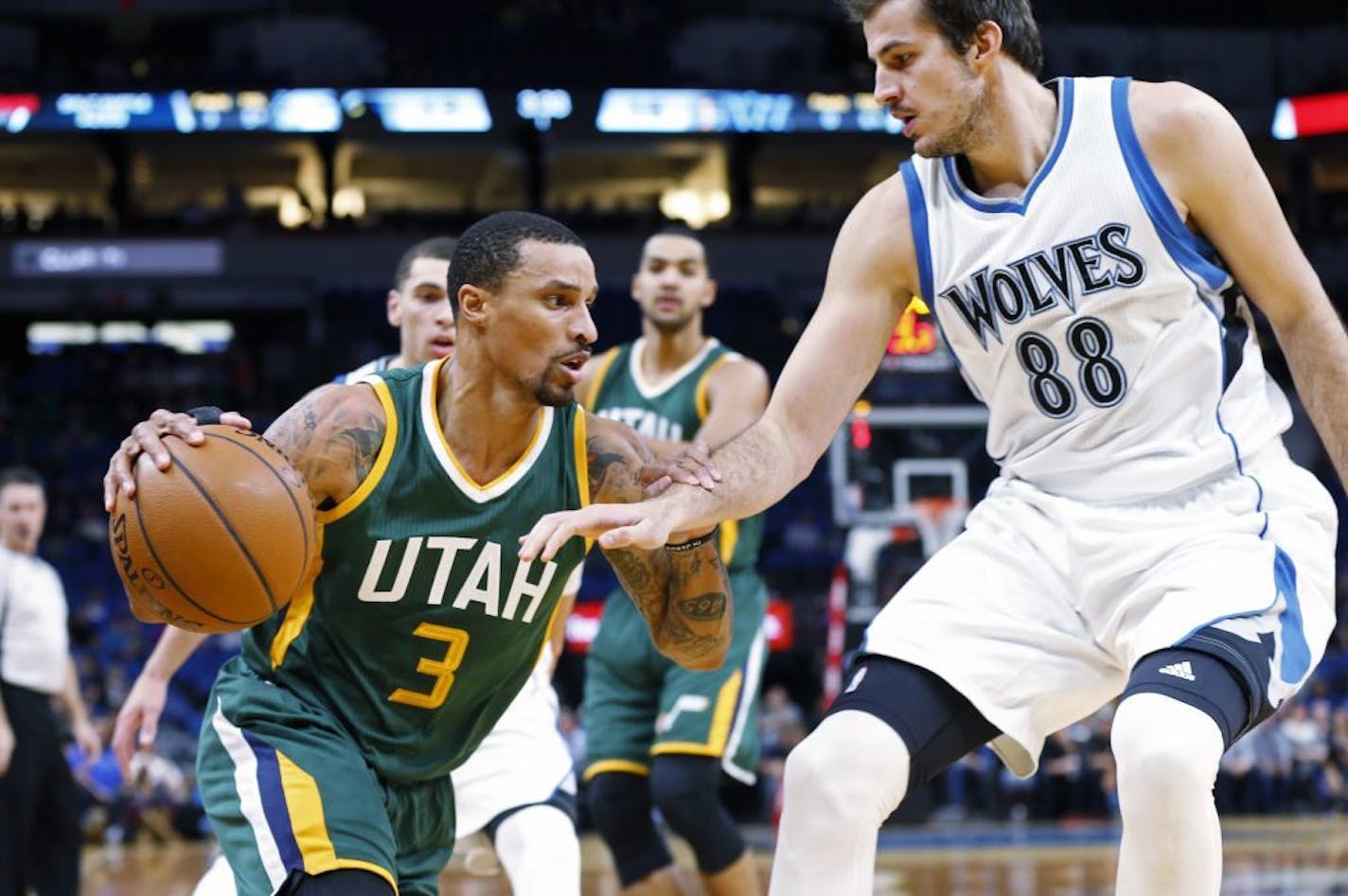 Utah Jazz's George Hill, left, drives around Minnesota Timberwolves' Nemanja Bjelica of Serbia in the first quarter of an NBA basketball game Monday, Nov. 28, 2016, in Minneapolis.
