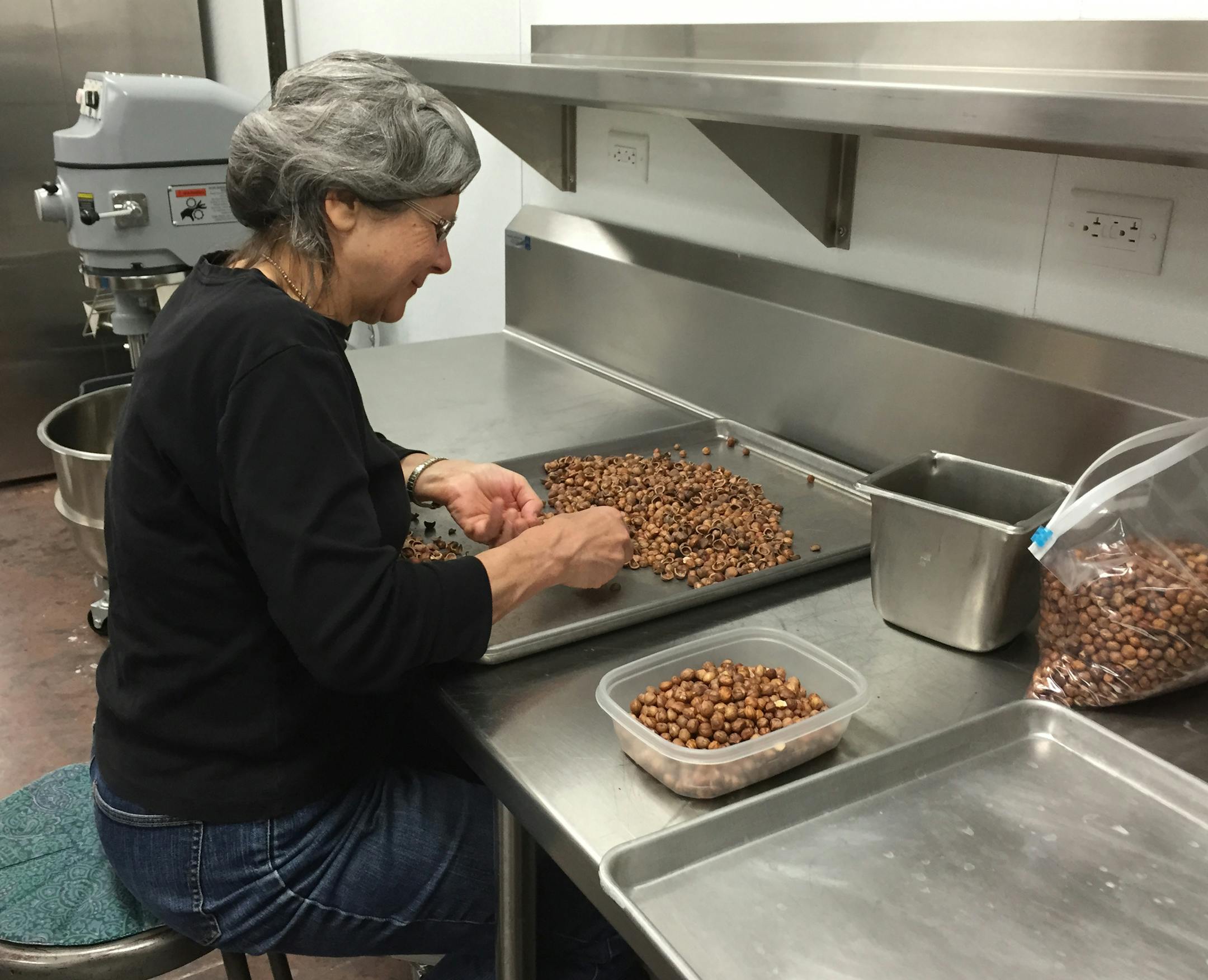 Debra Reak sorted through hybrid hazelnuts at a facility in Wisconsin, which is estimated to have about 100 farmers growing hybrid hazelnuts.