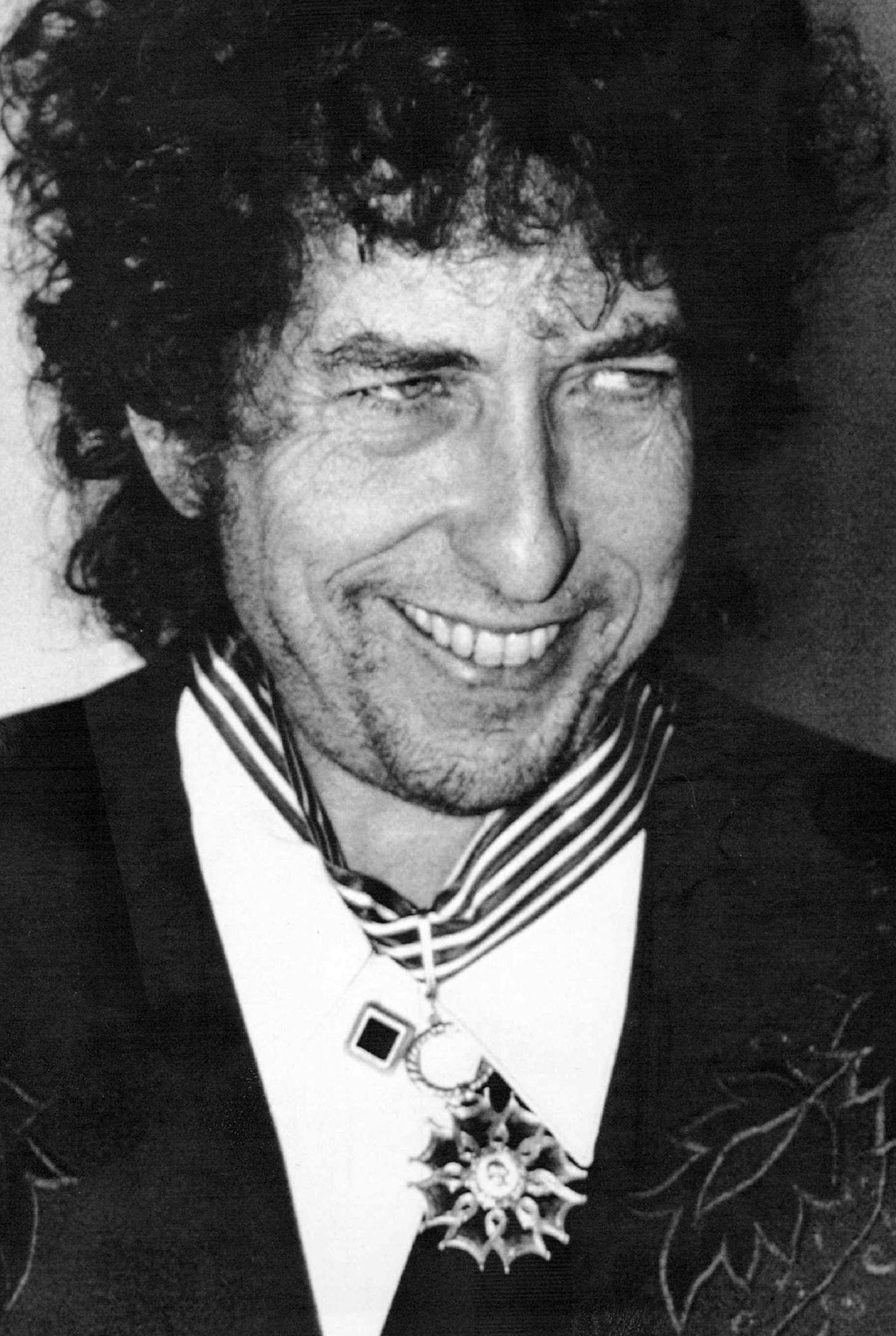 January 30,1990 Dylan Awarded - American rock and folk legend Bob Dyland flashes a smile after he was named a Commander in France's Order of Arts and letters by French culture minister Jack Lang in a ceremony here Tuesday.Dylan is giving a series of concerts in Paris as part of his European tour.
