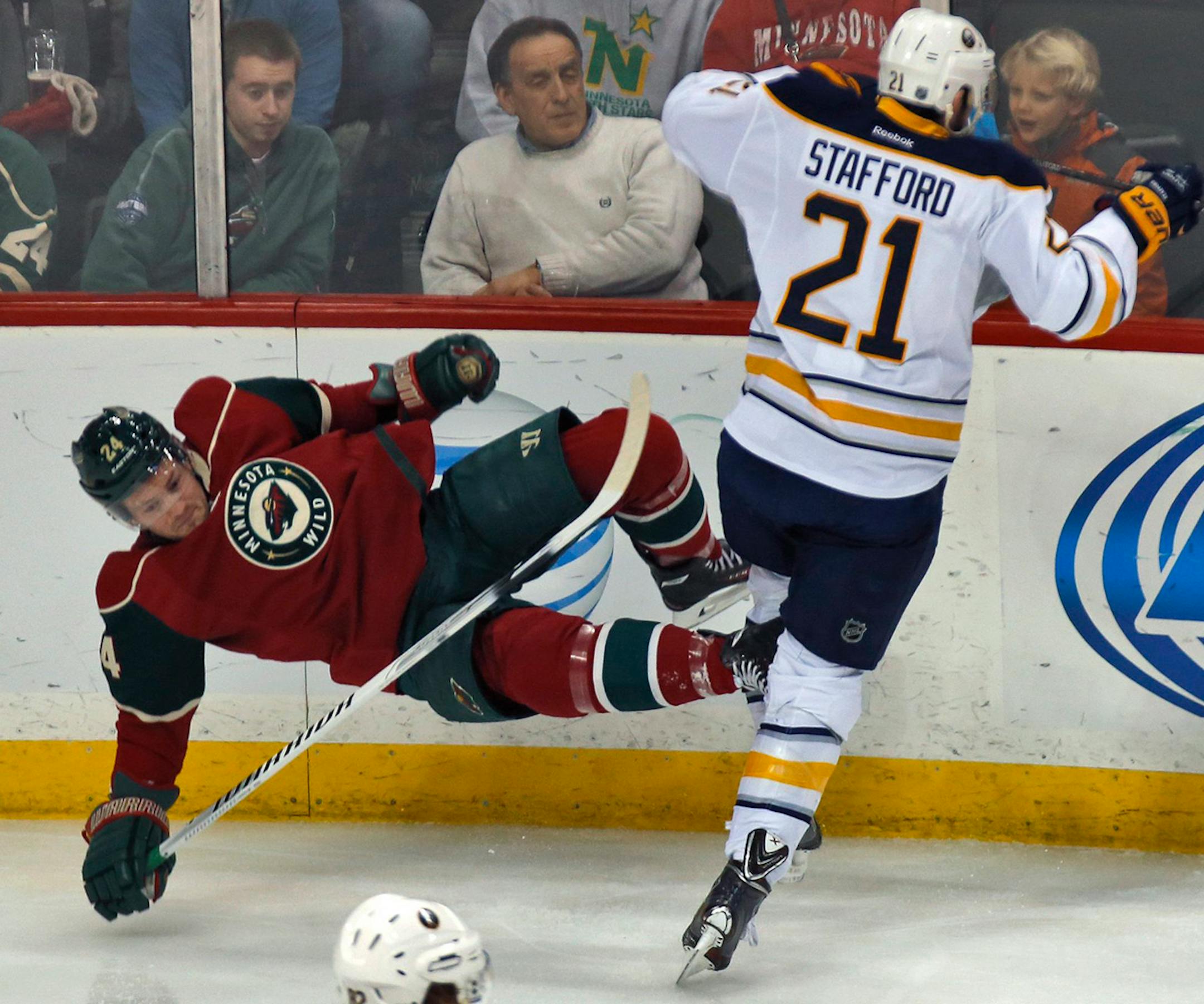 The Buffalo Sabres' Drew Stafford (21) sends the Minnesota Wild's Matt Cooke flying with a check in first-period action at the Xcel Energy Center in St. Paul, Minn., on Thursday, Jan. 2, 2014. The Wild won, 4-1. (Marlin Levison/Minneapolis Star Tribune/MCT) ORG XMIT: 1147440