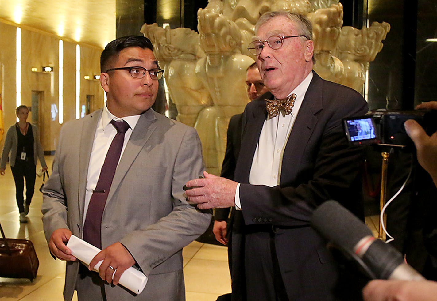 Officer Jeronimo Yanez, left, walked with his attorney Tom Kelly, right, and other legal team members while leaving the Ramsey County Courthouse Tuesday, May 30, 2017, in St. Paul.