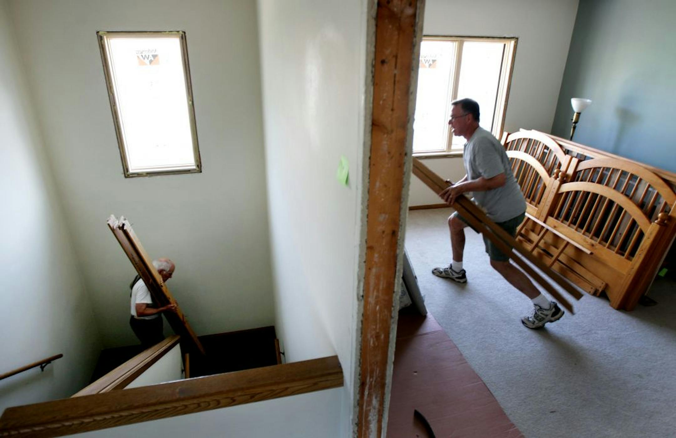 Jim Jacobs left and Dean Sherburne removed wood from a door frame during the renovation of the priest rectory at Guardian Angles Church Monday July 16, 2012 In Oakdale ,MN. The rectory is being converted to an eight-bedroom homeless shelter.