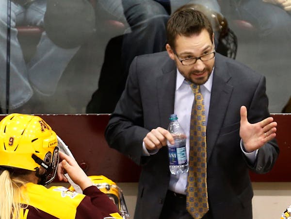 Head coach Brad Frost gave some pointers to his players.] At Ridder Arena in women's WCHA Final Face-Off Championship game Fbetween the Gophers and Ba