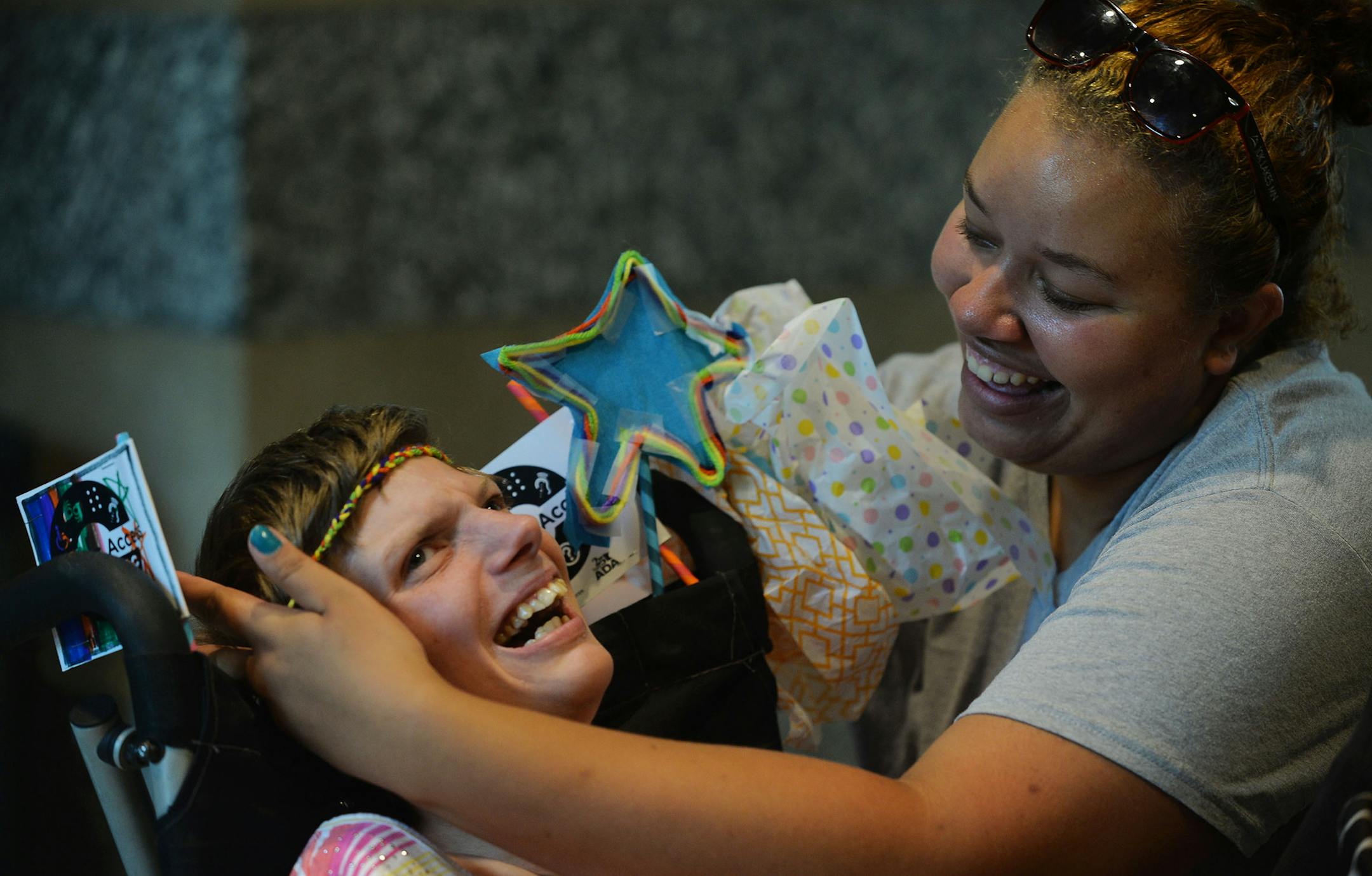 From left, Tara Carlson laughed while Sam Blanks, both of Blaine, put a newly crafted headband on her forehead. The Minnesota State Council on Disability and the disability community celebrated the 25th Anniversary of the signing of the Americans with Disabilities Act (ADA) with a family day of events at the Minnesota History Center in St. Paul Minn., on Sunday July 26, 2015. ] RACHEL WOOLF ∑ rachel.woolf@startribune.com