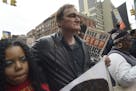 Director Quentin Tarantino, center, participates in a rally to protest against police brutality Saturday, Oct. 24, 2015, in New York. Speakers at the 