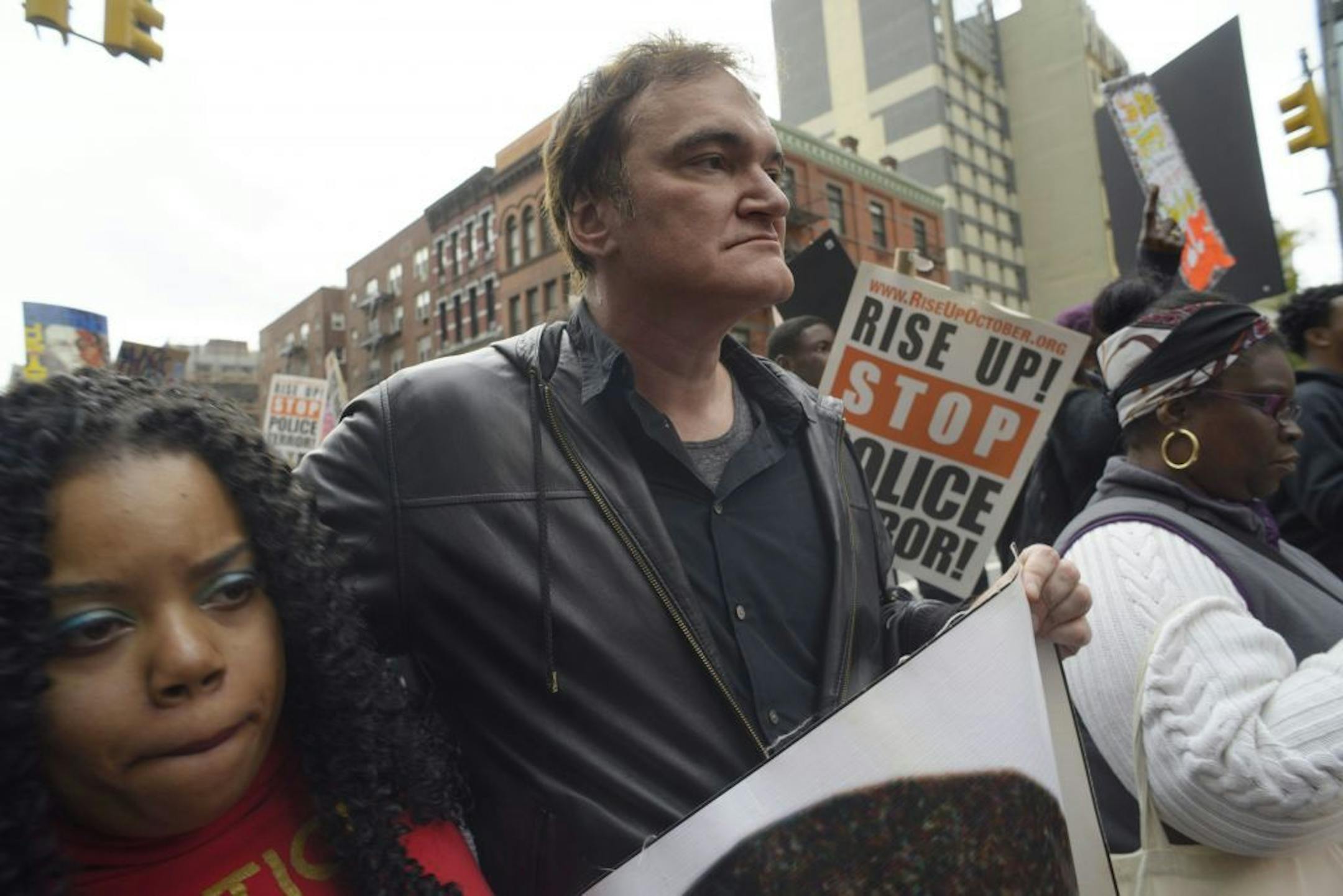 Director Quentin Tarantino, center, participates in a rally to protest against police brutality Saturday, Oct. 24, 2015, in New York. Speakers at the protest said they want to bring justice for those who were killed by police.