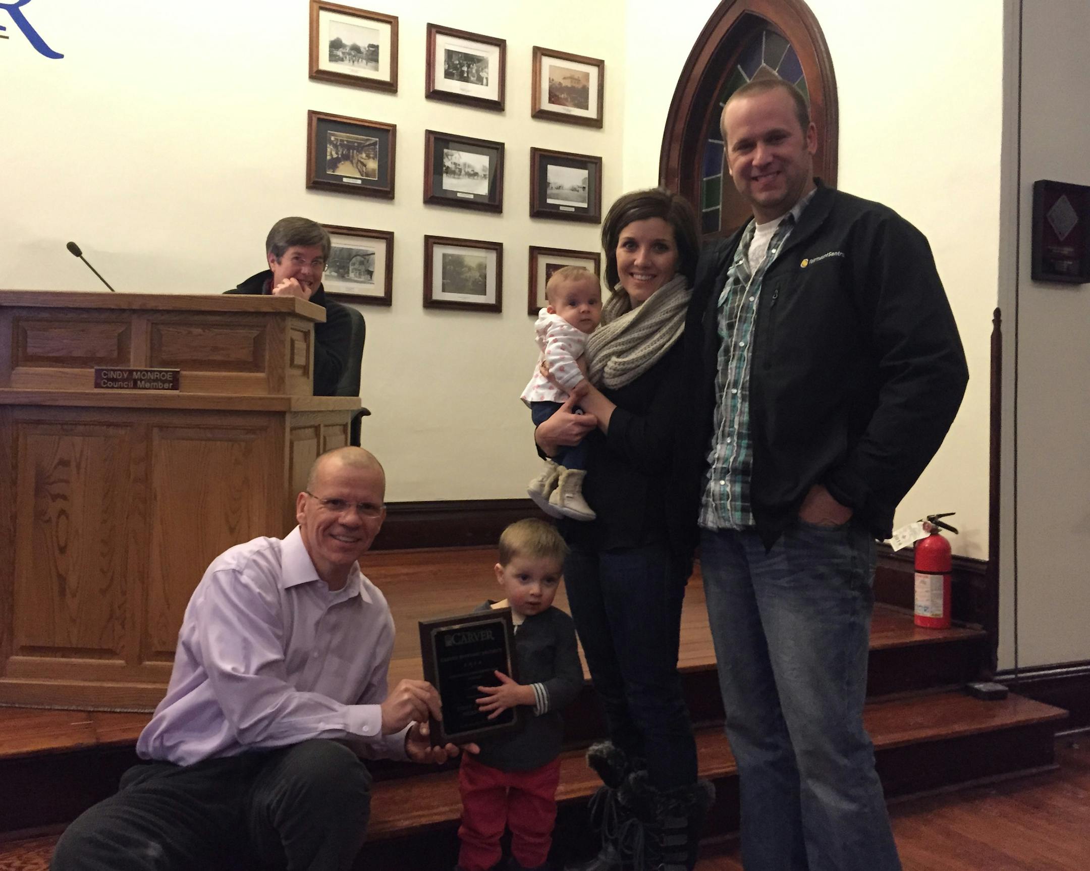 The Hergotts were recognized this month for the restoration of their 1868 house in the Carver Historic District. Carver Mayor Mike Webb held a plaque with one of the family honorees.