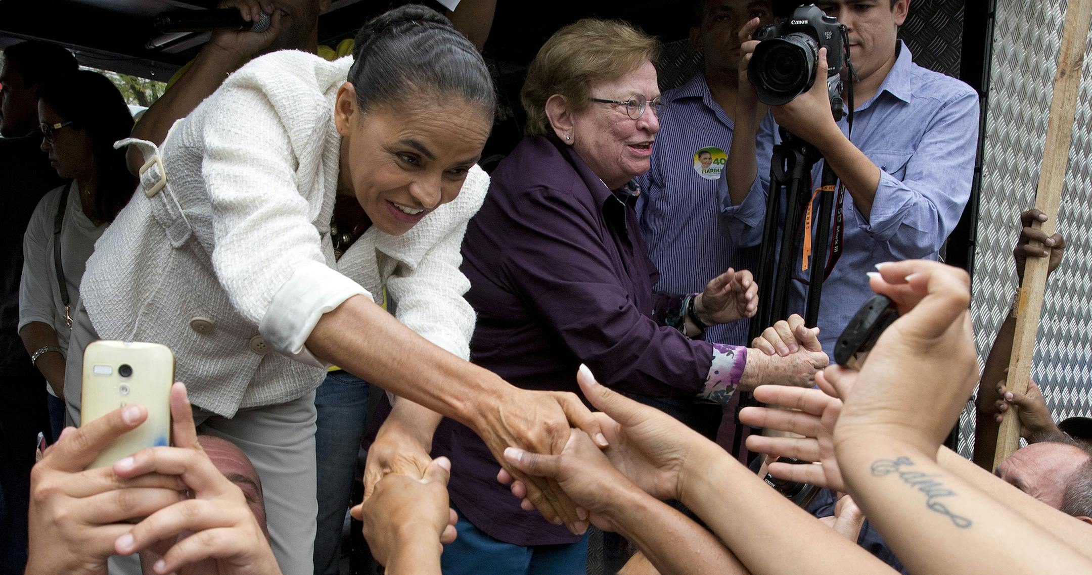 Marina Silva, Brazilian Socialist Party presidential candidate, greets supporters at a campaign rally in Sao Bernardo do Campo, Brazil, Friday, Sept. 19, 2014. Silva is running in a neck-and-neck race with Brazilian President Dilma Rousseff, who is seeking re-election. Brazil will hold general elections on Oct. 5.(AP Photo/Andre Penner) ORG XMIT: MIN2014092212334915