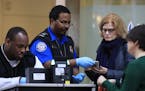 Transportation Security Administration workers screen airline passengers at Reagan Washington National Airport in Washington, Monday, Jan. 28, 2019, a