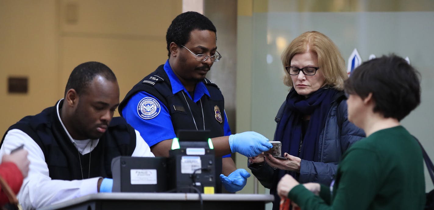 Transportation Security Administration workers screen airline passengers at Reagan Washington National Airport in Washington, Monday, Jan. 28, 2019, as federal workers and government contract workers return to work ending the record 35-day partial federal shutdown which began before Christmas. (AP Photo/Manuel Balce Ceneta)