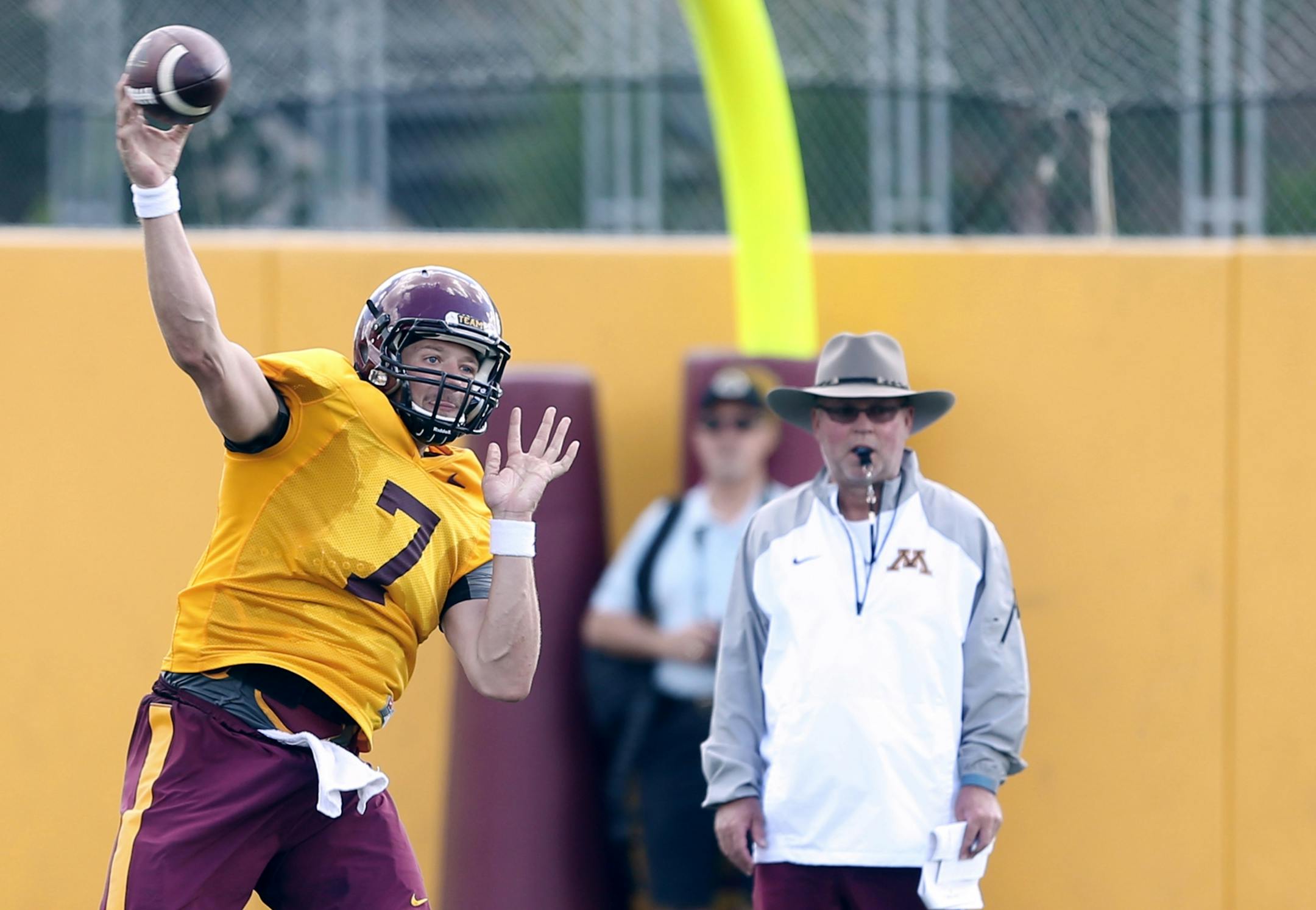 Quarterback Mitch Leidner threw a pass as coach Jerry Kill watched . The University of Minnesota football team had it's first full practice Monday August 10, 2015 in Minneapolis, MN.