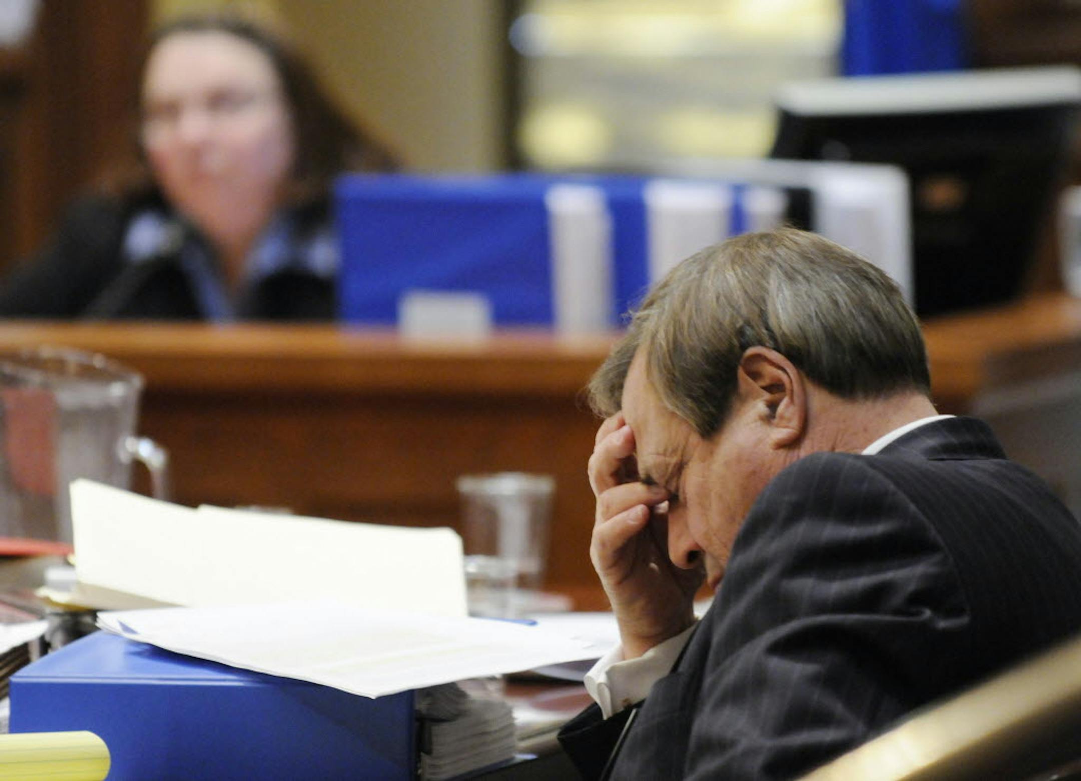 Norm Coleman attorney Joe Friedberg rests his eyes as Pamela Howell, background, is cross examined by Al Franken's attorneys during the Senate vote recount trial Monday.