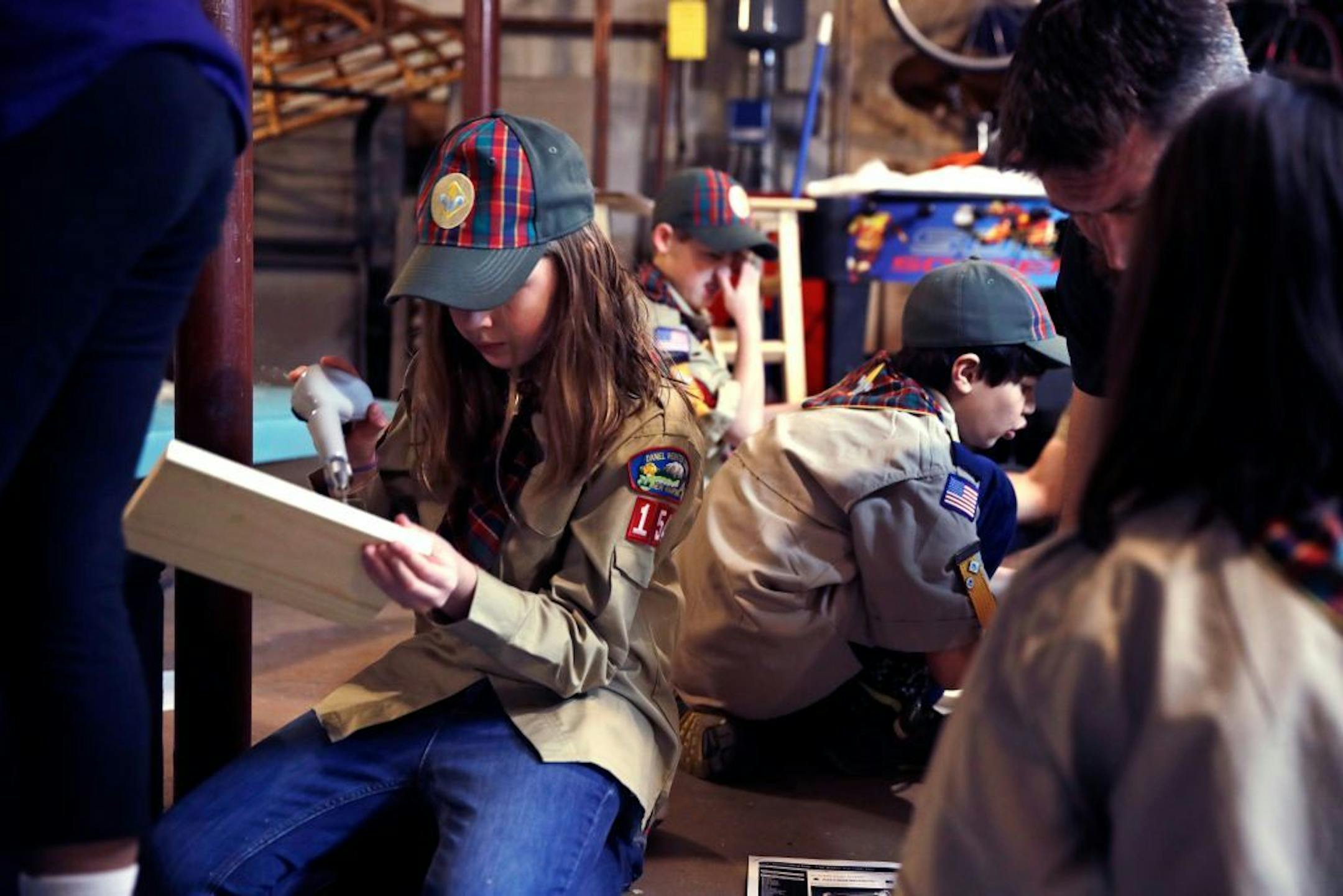 In a Thursday, March 1, 2018 photo, Tatum Weir, left, sets to drill a pilot hole while building a tool box during a cub scout meeting in Madbury, N.H. Fifteen communities in New Hampshire are part of an "early adopter" program to allow girls to become Cub Scouts and eventually Boy Scouts. Tatum and her twin brother Ian are planning to become the first set of girl-boy siblings to become Eagle Scouts.