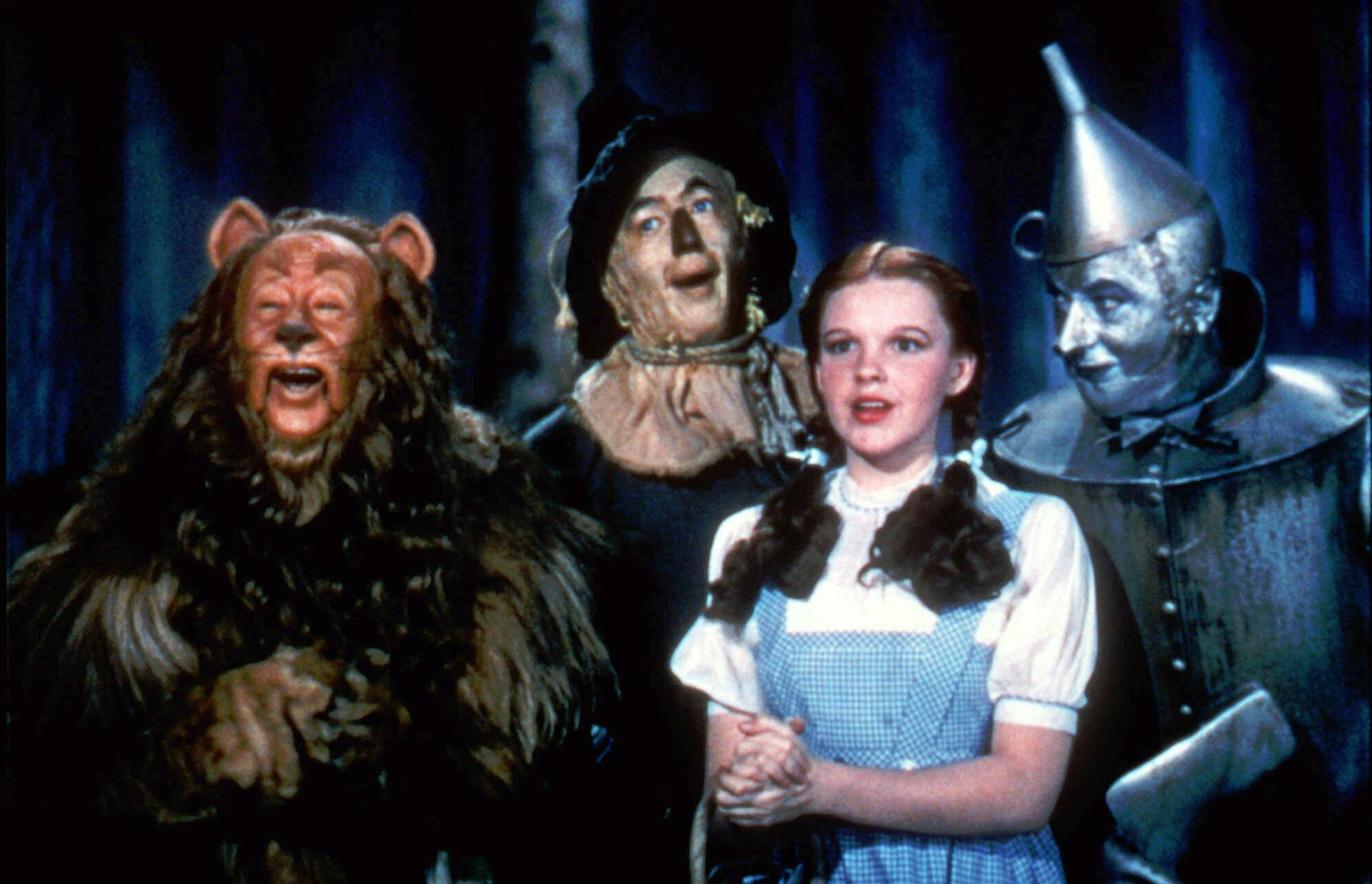 ** FILE ** In this file photo, Bert Lahr as the Cowardly Lion, Ray Bolger as the Scarecrow, Judy Garland as Dorothy, and Jack Haley as the Tin Woodman, sing in this scene from "The Wizard of Oz," distributed by Warner Bros. The film is among the American Film Institute's best genre movies. (AP Photo/HO,Warner Bros) ORG XMIT: MIN2013020610182314