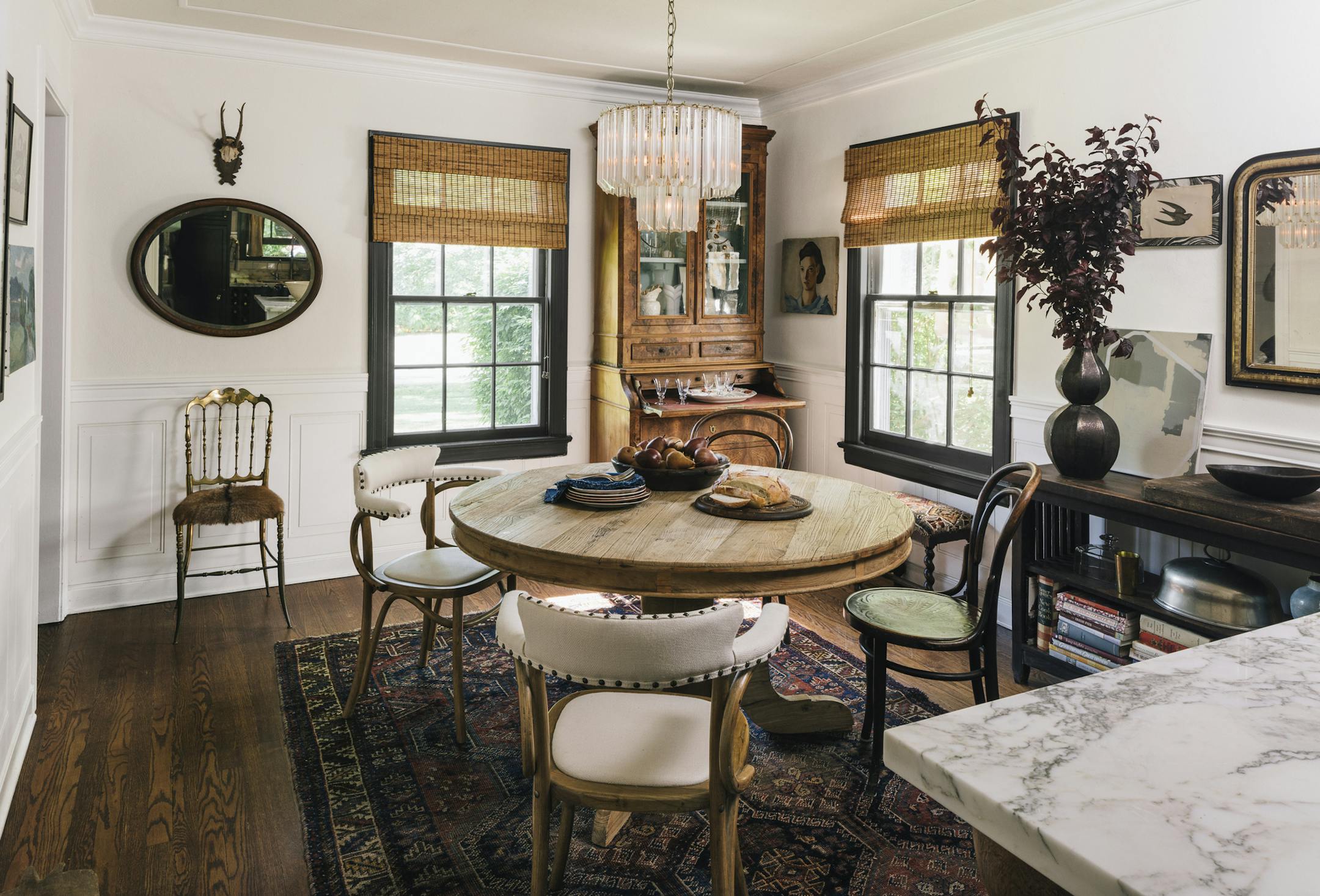 Mix old and new: In the dining room, a Venini glass chandelier is a modern foil to a vintage burl-wood cabinet.