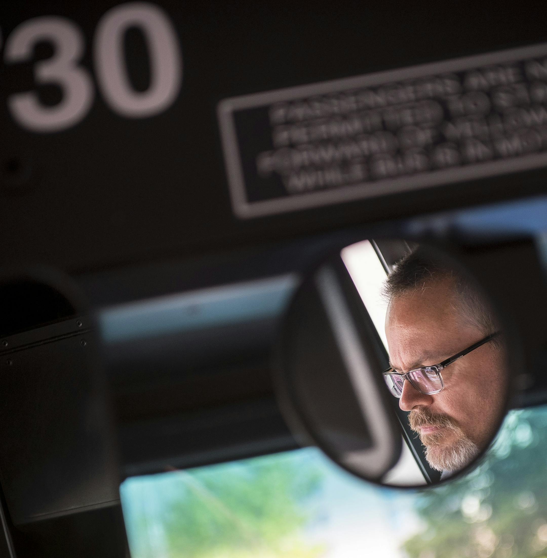 New Metro Transit bus driver James Hitz watched the road as he drove passengers through downtown Minneapolis Thursday. ] (AARON LAVINSKY/STAR TRIBUNE) aaron.lavinsky@startribune.com We photograph new Metro Transit bus driver James Hitz, of Apple Valley, as he picked up and dropped off commuters along route 17F in Minneapolis on Thursday, May 19, 2016. "It's the best decision I've ever made," said Hitz of his decision to change career fields from office work to driving a bus. For now, Hitz works