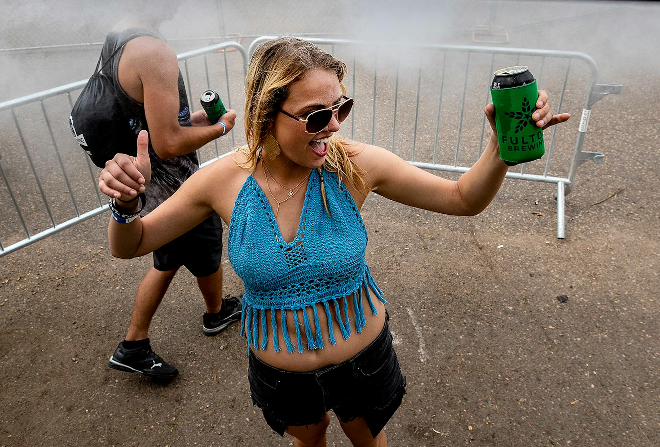 Alyssa Eisen, 23, of Osceola, Wis., cooled off under a mister.
