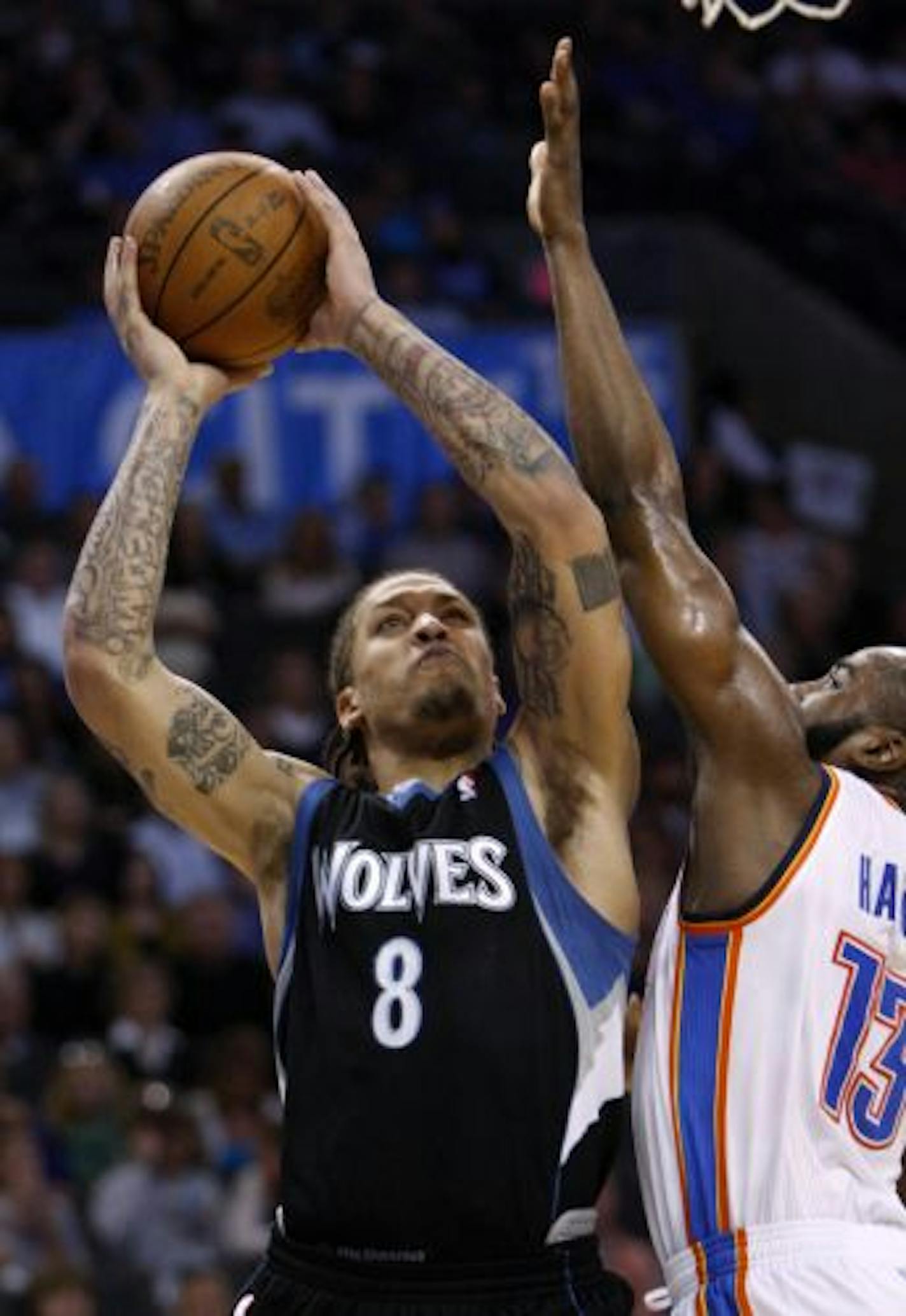 Minnesota Timberwolves forward Michael Beasley, left, shoots in front of Oklahoma City Thunder guard James Harden, right, in the second quarter of an NBA basketball game in Oklahoma City, Friday, March 25, 2011.