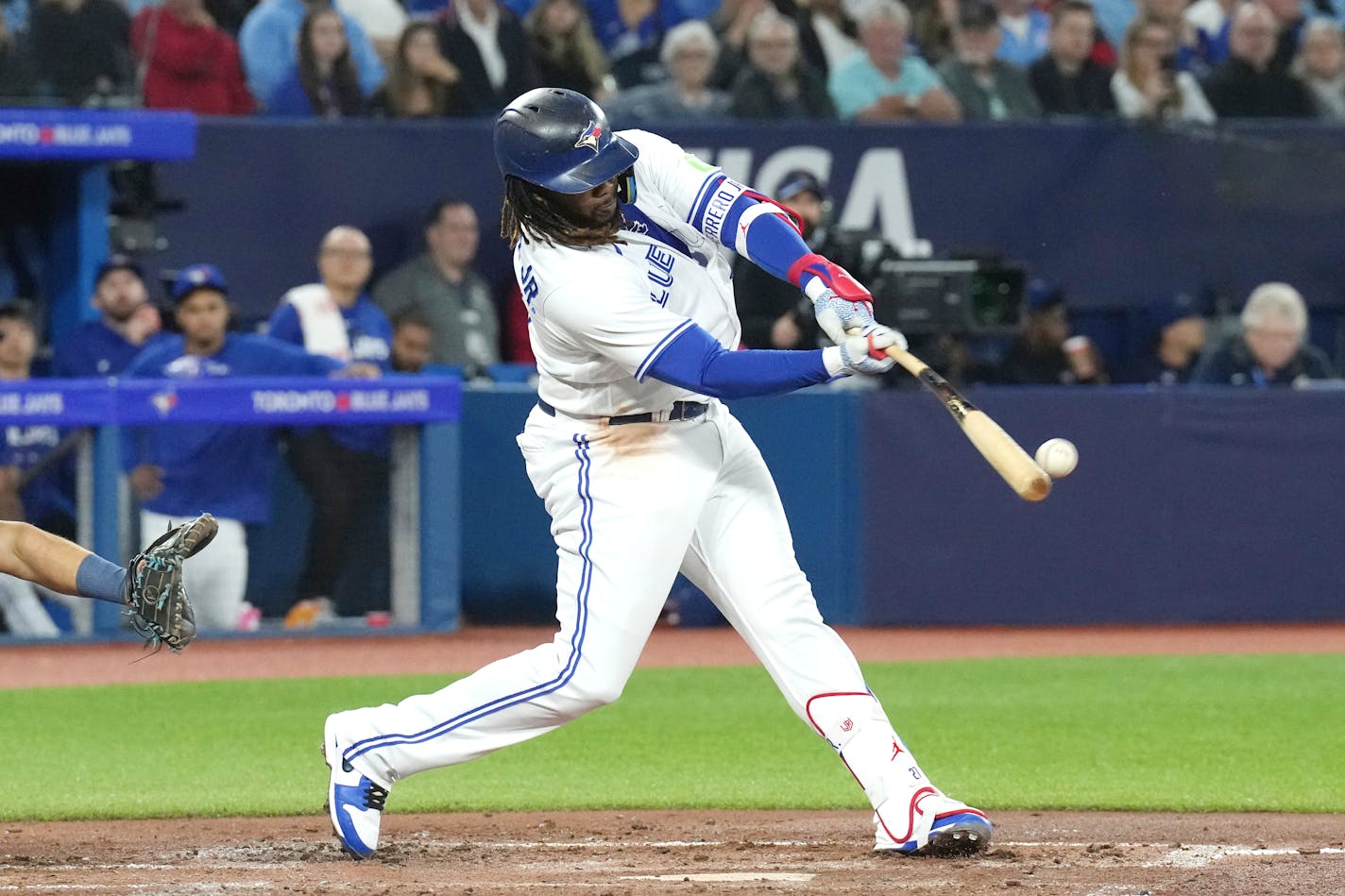 Toronto Blue Jays Vladimir Guerrero Jr. hits a single off Tampa Bay Rays relief pitcher Zack Littell during the third inning of a baseball game Friday, Sept. 29, 2023, in Toronto. (Chris Young/The Canadian Press via AP)