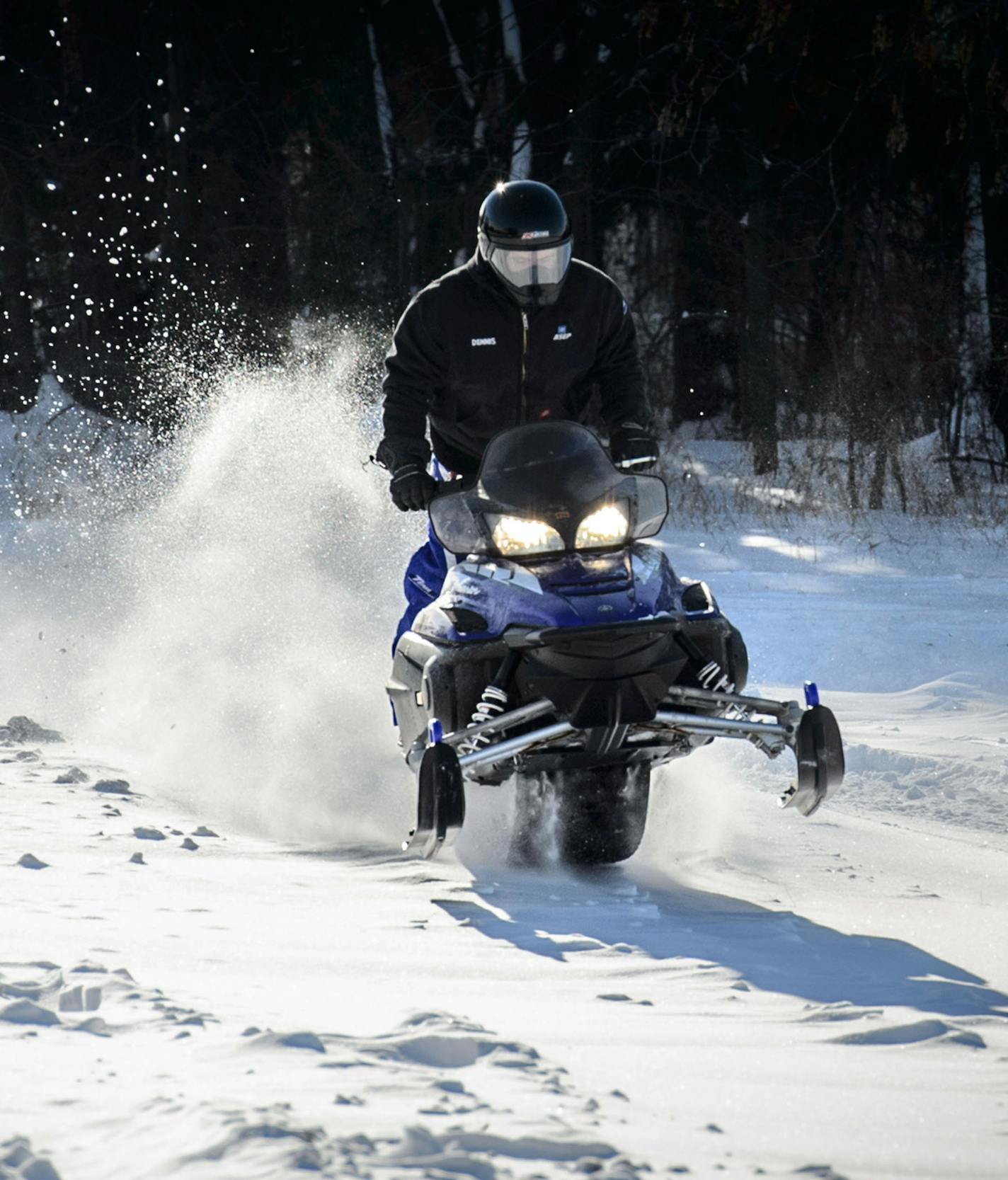 A snowmobiler caught some air over a driveway along Lake Drive NE in Lino Lakes. The Rice Creek Trail Association grooms more than 70 miles of trails in the Circle Pines/Lino Lakes area. Thursday, December 12, 2013 ] GLEN STUBBE * gstubbe@startribune.com ORG XMIT: MIN1312121724480701