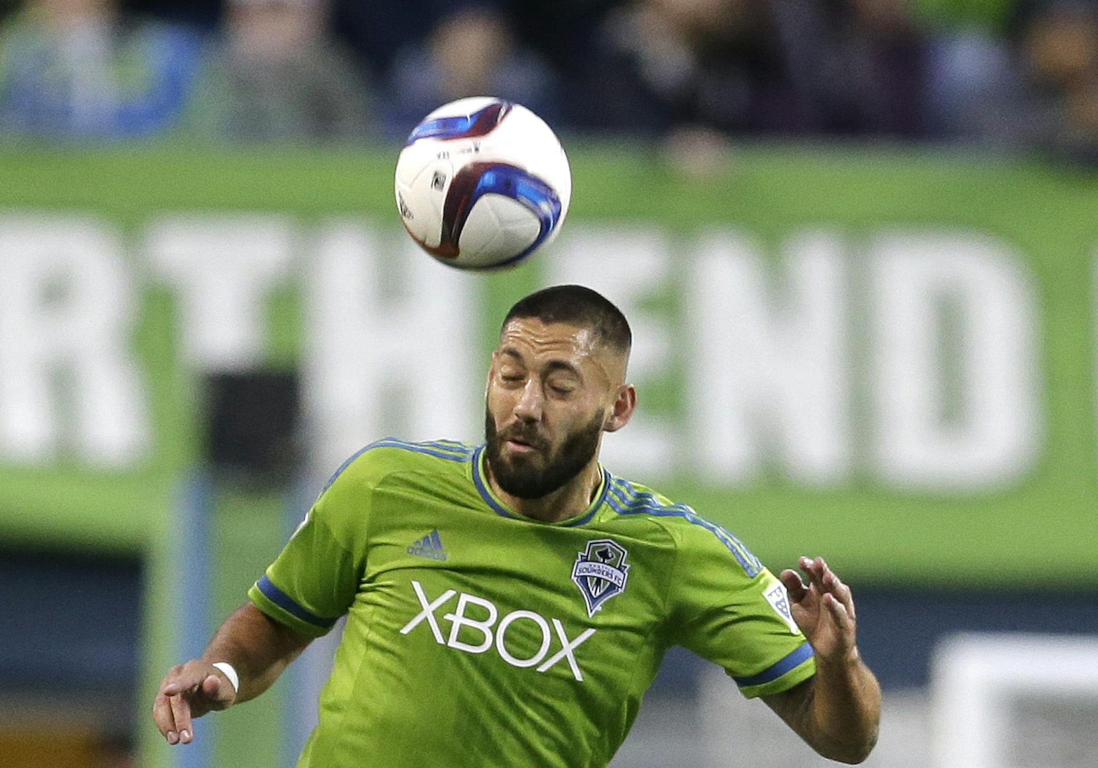 Seattle Sounders forward Clint Dempsey, heads the ball against the Houston Dynamo in the first half of an MLS soccer match, Saturday, April 4, 2015, in Seattle. (AP Photo/Ted S. Warren)