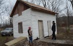 Sara Sturgis and Joe Deden of the Eagle Bluff Environmental Learning Center inspect a 19th-century cabin that came with a 151-acre tract of land recen