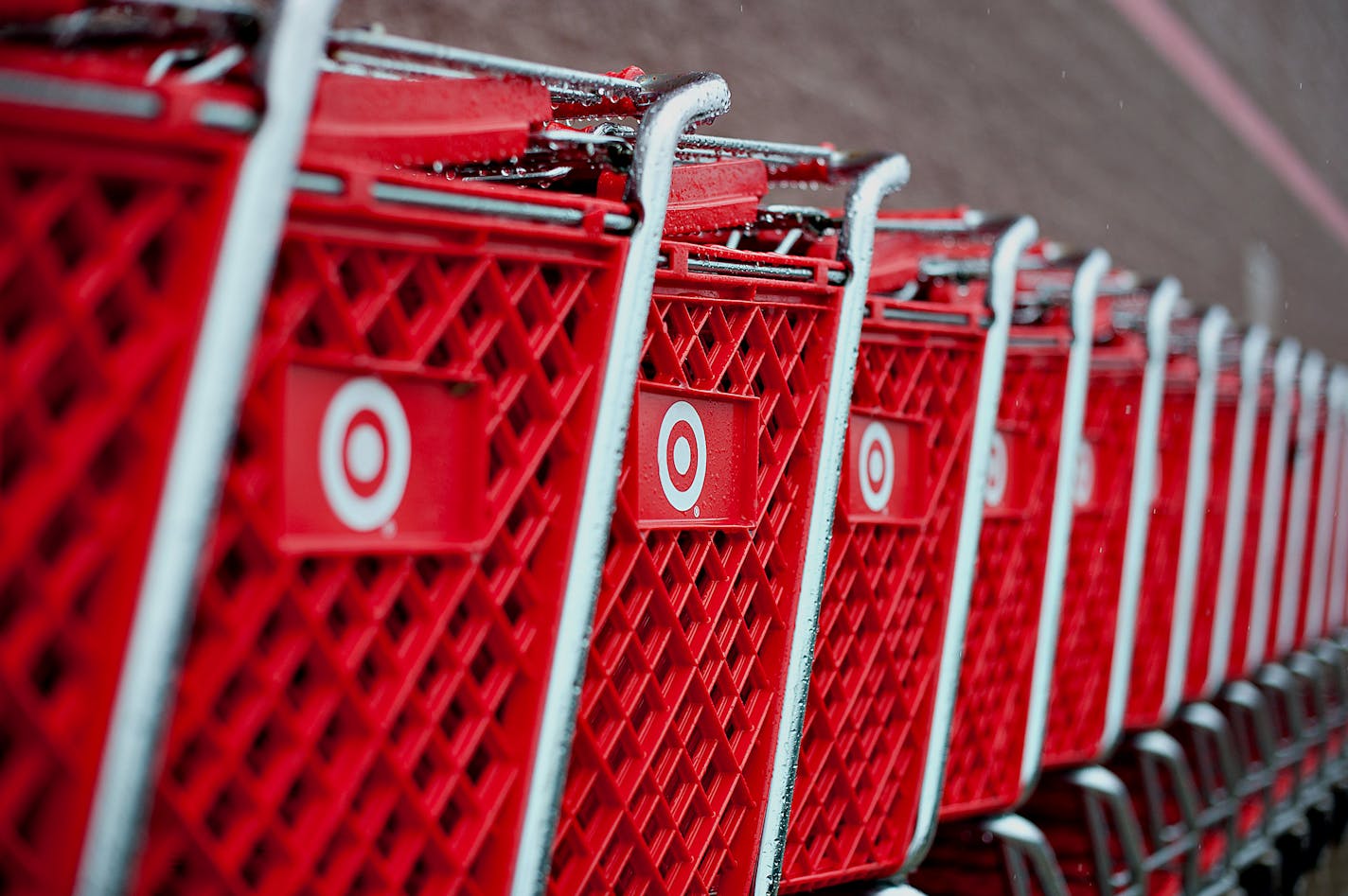 Rain drops sit on shopping carts outside a Target Corp. store in Peru, Illinois, U.S., on Thursday, Feb. 7, 2013. Target Corp. led U.S. retailers to the biggest monthly same-store sales gain in more than a year as shoppers snapped up discounted merchandise chains were clearing out after the holidays. Photographer: Daniel Acker/Bloomberg