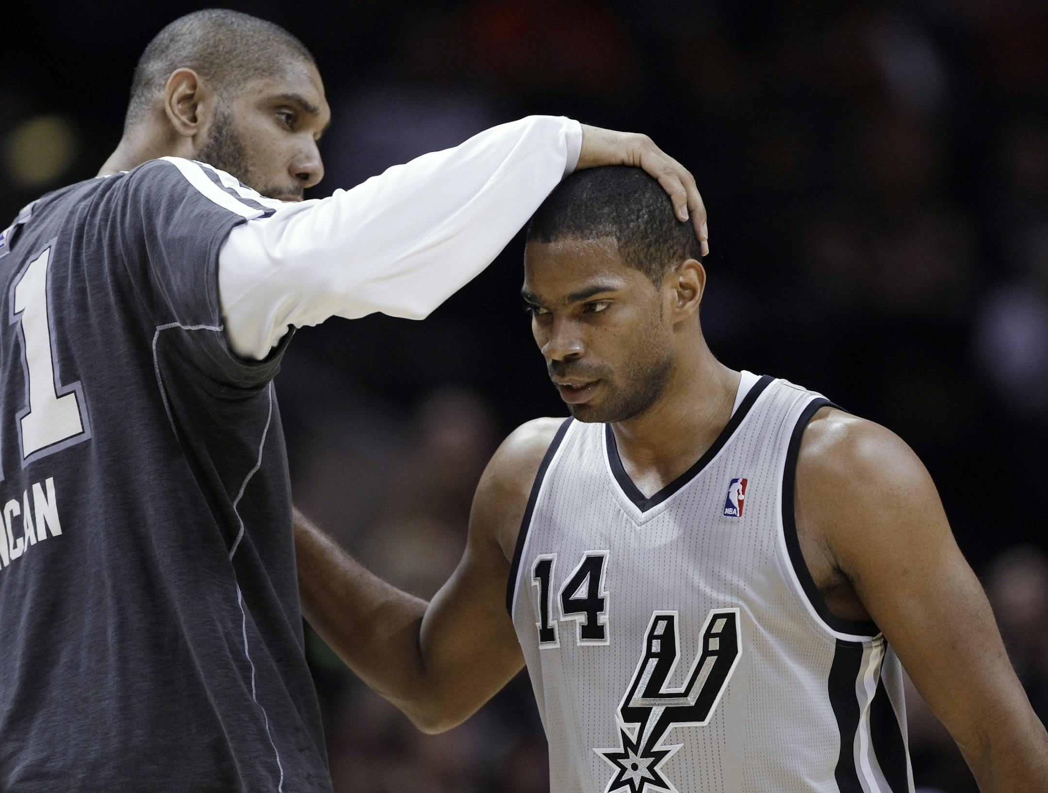 San Antonio Spurs' Tim Duncan, left, pats teammate Gary Neal on the head after Neal hit a 3-point shot during the fourth quarter of an NBA basketball game against the Minnesota Timberwolves, Sunday, Jan. 13, 2013, in San Antonio. San Antonio won 106-88.
