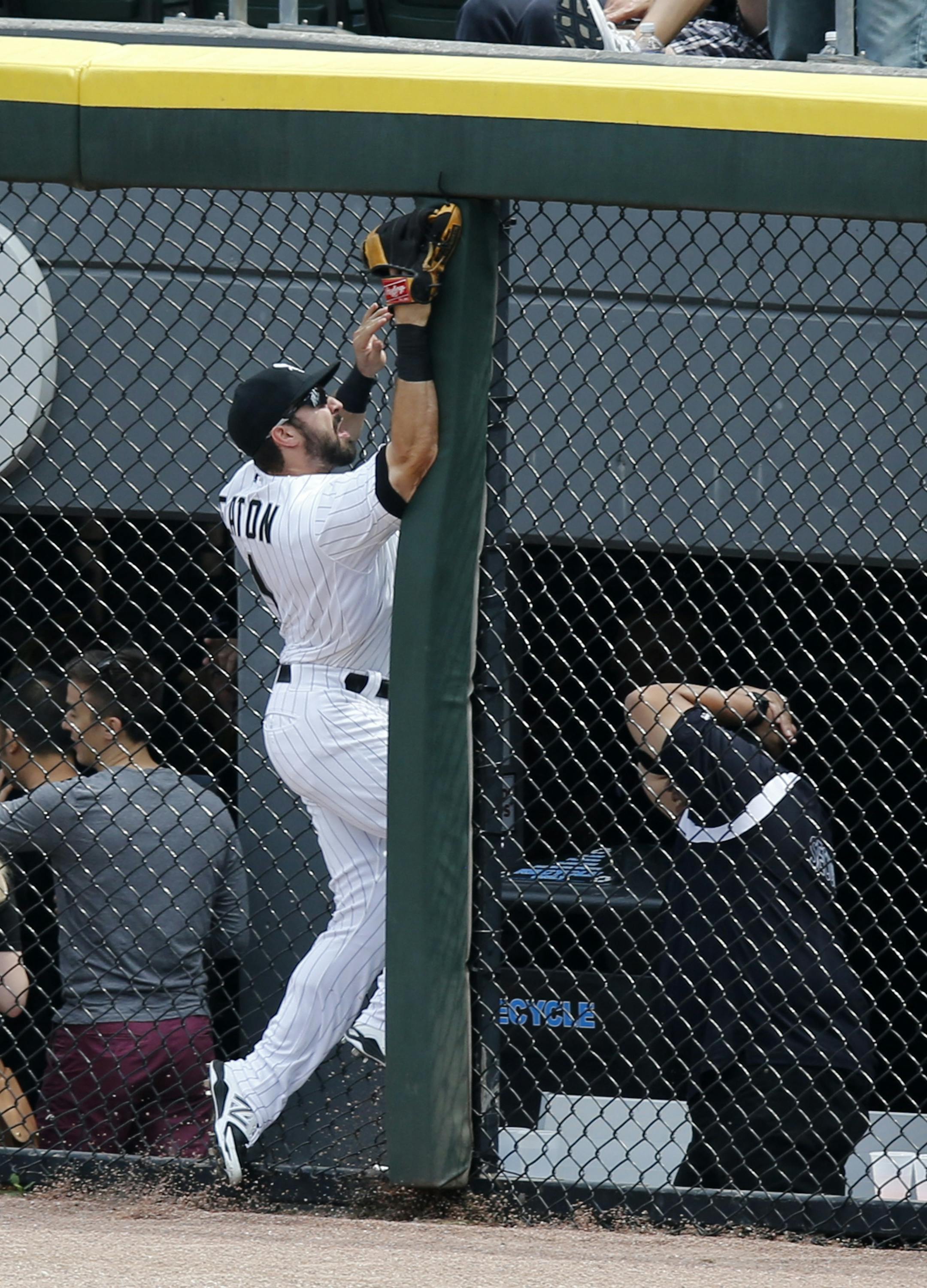 Chicago White Sox center fielder Adam Eaton slams into the right center field fence chasing a two-run home run by Texas Rangers' Adam Rosales during the second inning of a baseball game Wednesday, Aug. 6, 2014, in Chicago. (AP Photo/Charles Rex Arbogast)
