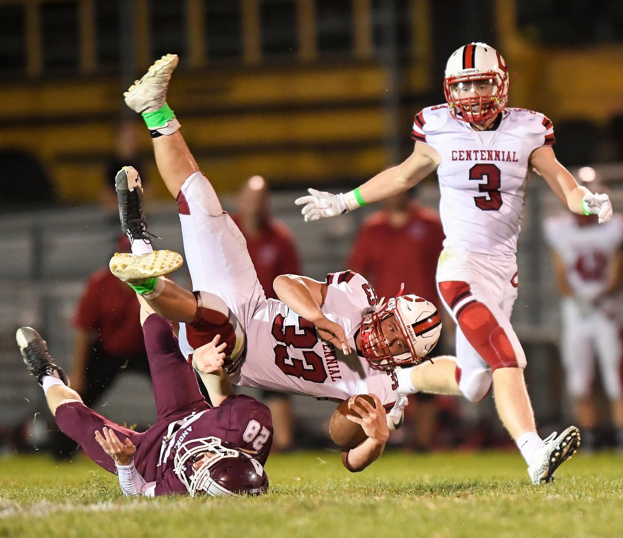 Centennial running back Sam Bonfe (33) was upended by Anoka defensive back Scotty Springer (28) as he rushed for a first down in the third quarter Friday night. ] AARON LAVINSKY ï aaron.lavinsky@startribune.com Centennial played Anoka in a high school football game on Friday, Sept, 15, 2017 at Anoka High School in Anoka, Minn.