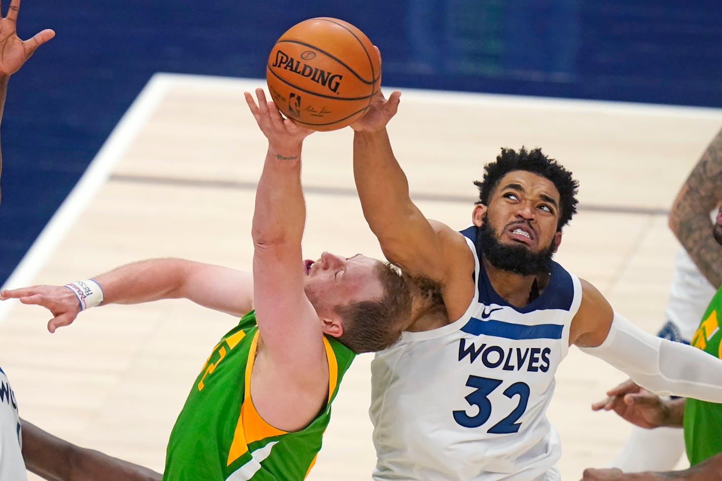 Minnesota Timberwolves center Karl-Anthony Towns (32) blocks Utah Jazz guard Joe Ingles, left, in the second half during an NBA basketball game Saturday, April 24, 2021, in Salt Lake City. (AP Photo/Rick Bowmer)