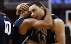 Penn State's D.J. Newbill hugs Ross Travis (43) after an NCAA college basketball game against Nebraska in the first round of the Big Ten Conference to