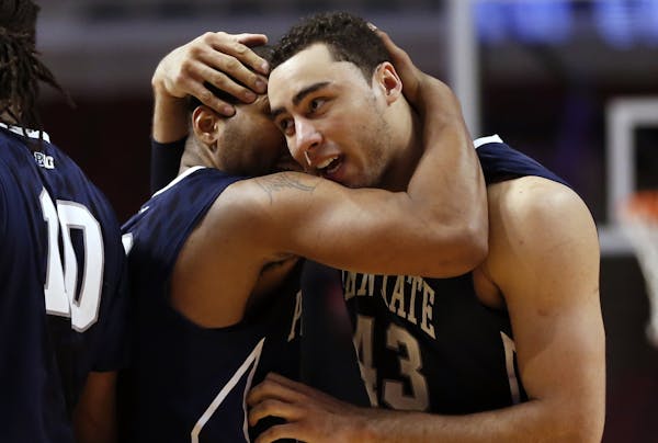 Penn State's D.J. Newbill hugs Ross Travis (43) after an NCAA college basketball game against Nebraska in the first round of the Big Ten Conference to