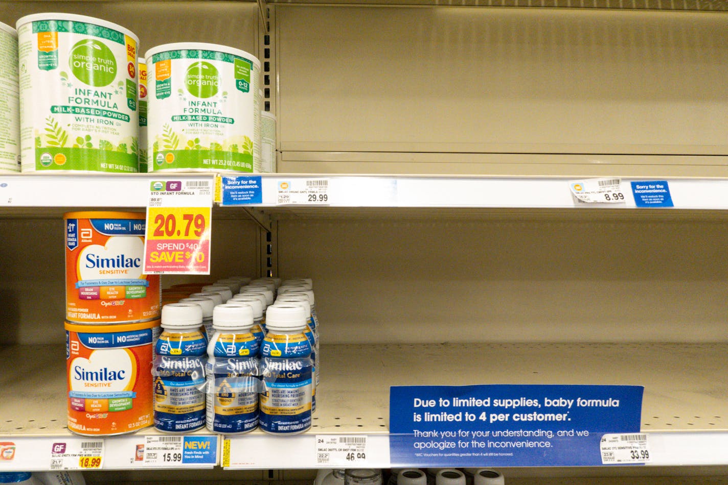 Baby formula on a store shelf.