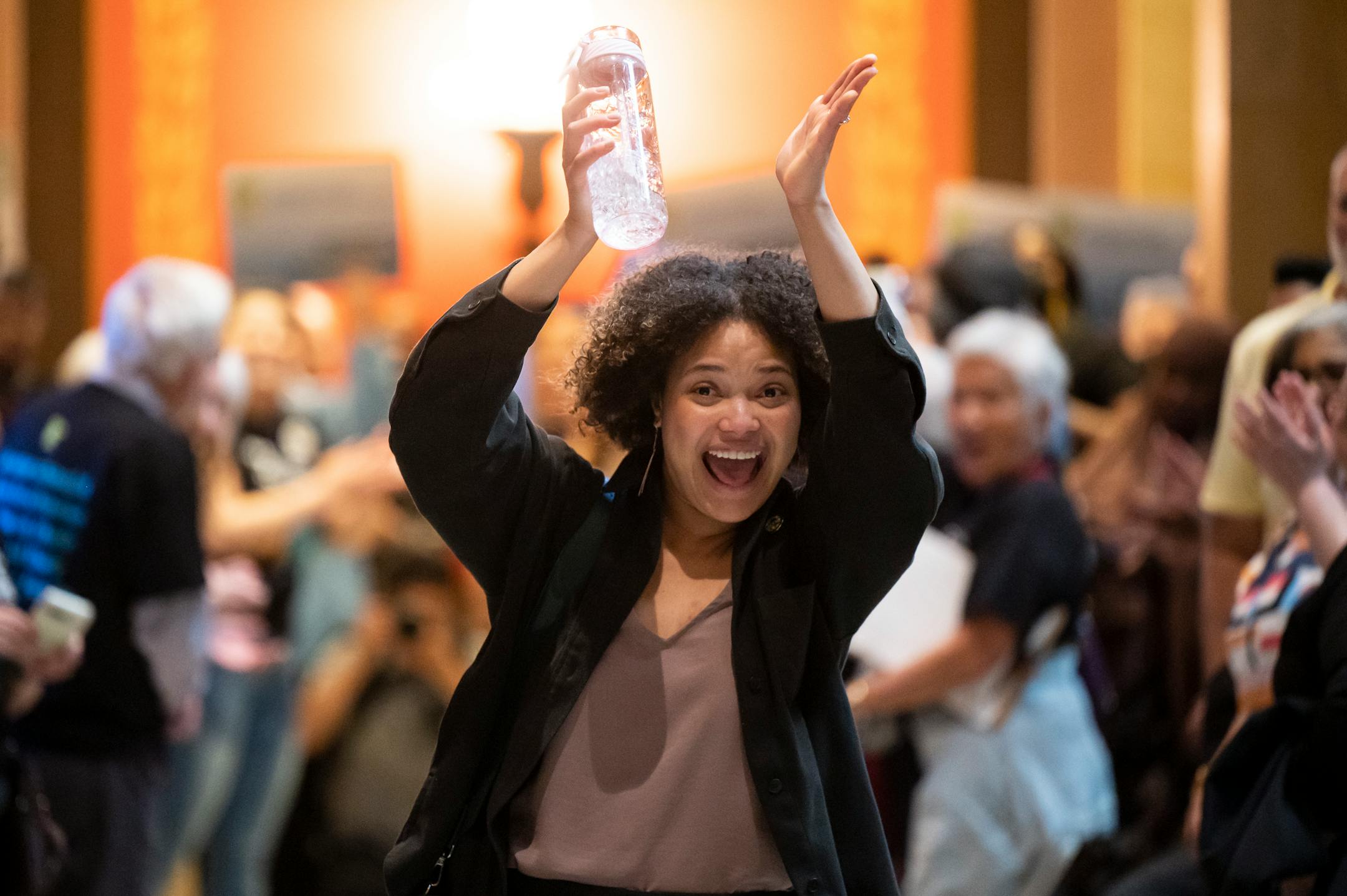 Sen. Clare Oumou Verbeten, DFL-St. Paul, is cheered by paid family leave supporters as she makes her way toward the Senate Chambers Monday at the Minnesota State Capitol.