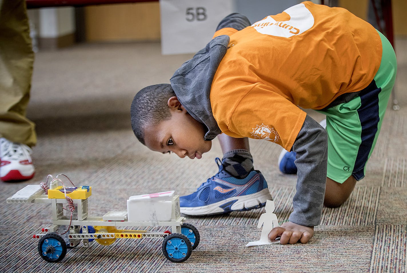 Matthewos Michael, 10, cq, took a closer look at his team's remote car during a competition at the STEM camp at Earle Brown Elementary school, Friday, July 20, 2018 in Brooklyn Center, MN. The summer program is aimed at introducing black students to STEM (science, technology, engineering and math) coursework. The National Society of Black Engineers, which sponsors the program, has a goal of graduating 10,000 black engineers annually by 2025. The summer program, which runs through July 27, now is