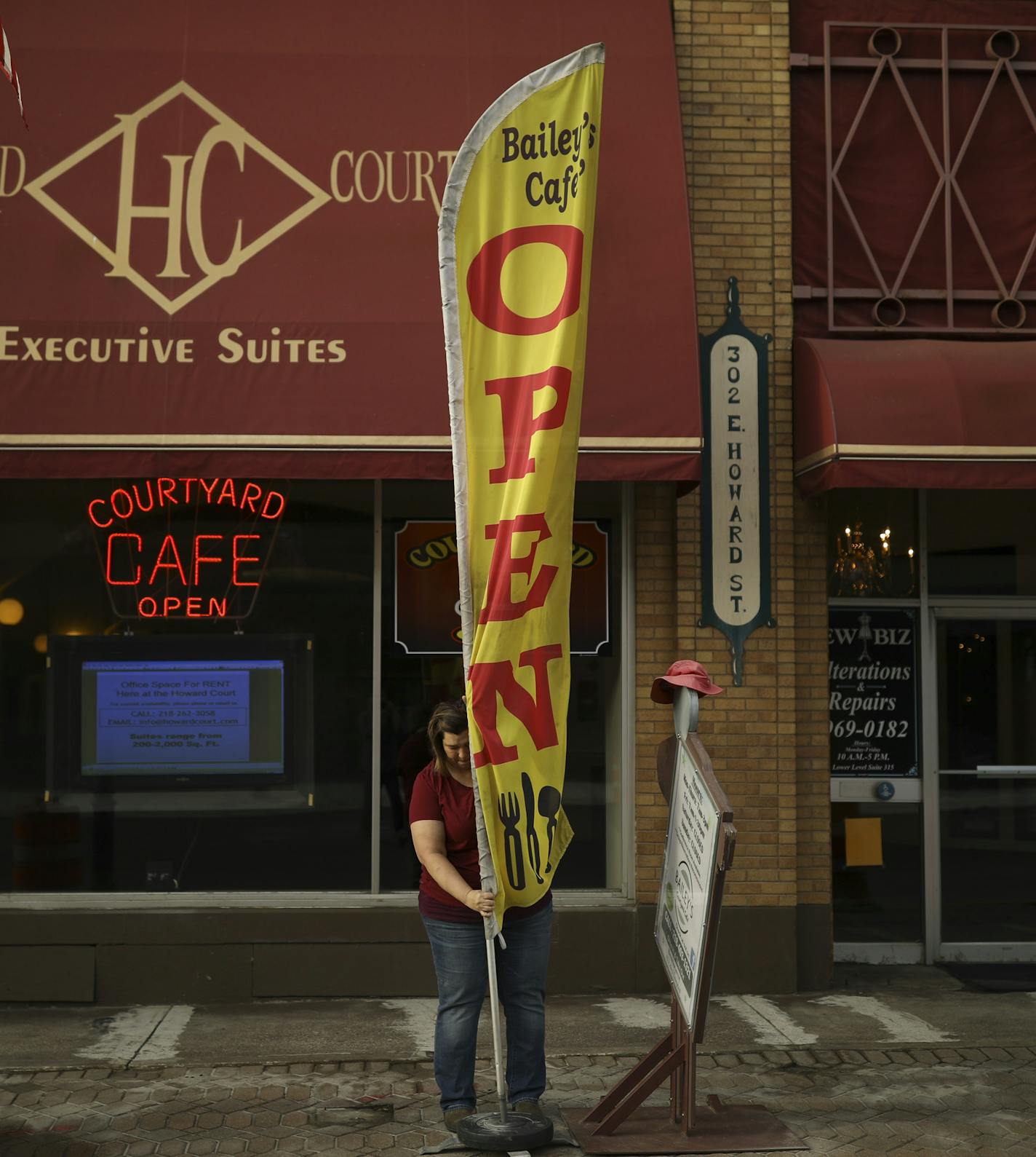 Tracy Bailey mounted the flag for her Bailey's Courtyard Cafe shortly after she and her husband, Jim, opened up for the day Thursday morning on E. Howard St. in downtown Hibbing. ] JEFF WHEELER &#xef; jeff.wheeler@startribune.com The economy on the Iron Range is in a boom cycle currently with mines operating and new business betting on the current upswing lasting. The breakfast rush at Bailey&#xed;s Courtyard Caf&#xc8; in downtown Hibbing was photographed Thursday morning June 14, 2018.