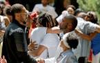 FILE -- Pastor Danny Givens, front right, shakes hands with a mourner following a celebration of life service for Le'Vonte King Jason Jones, 2, shot a