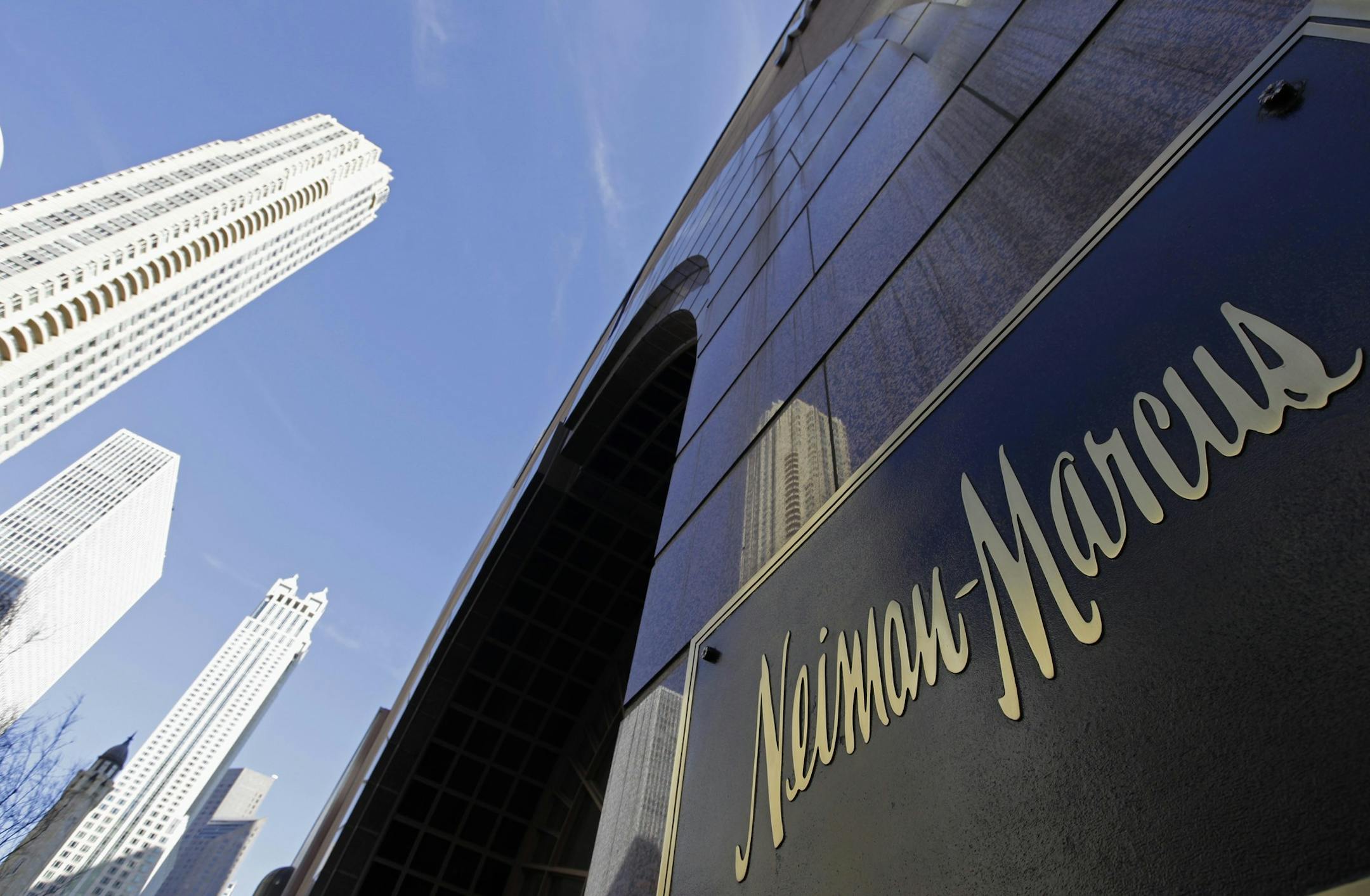 FILE - In this Wednesday, March 11, 2009 file photo, the Chicago skyline is reflected in the exterior of Neiman Marcus on Michigan Avenue in Chicago. Luxury retailer Neiman Marcus plans to raise up to $100 million from an initial public offering of its common stock, according to reports, Monday, June 24, 2013. (AP Photo/M. Spencer Green, File)