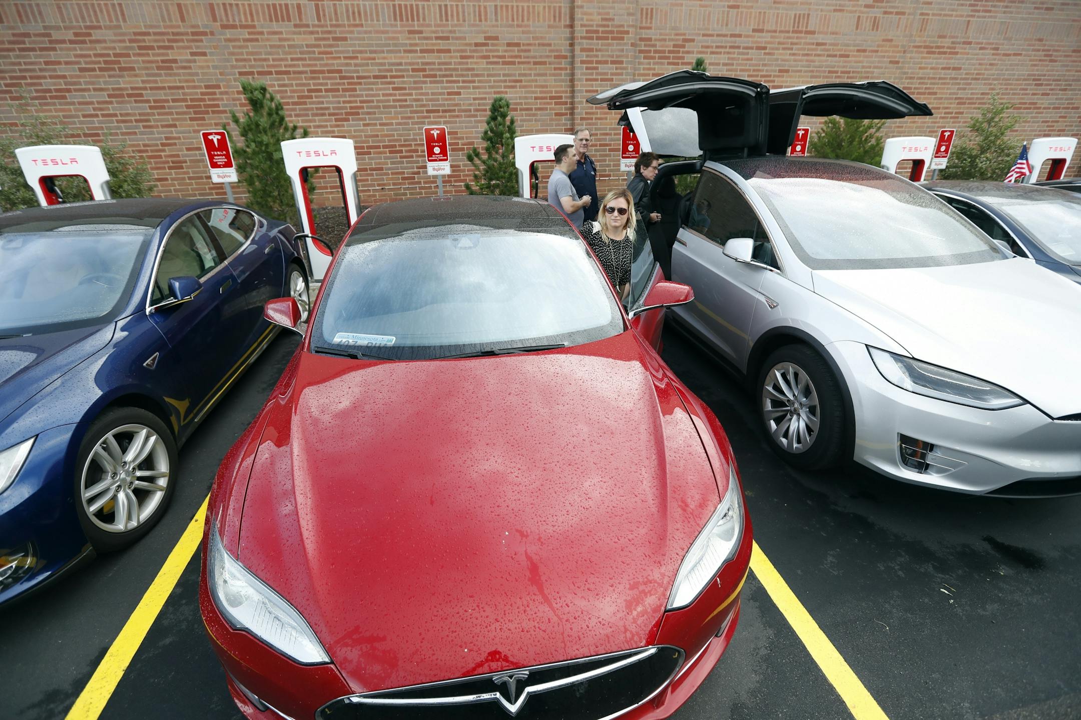Brittany Lee got into her 85D Tesla car after charging it a Hy-Vee storeTuesday September 13, 2016 in Oakdale, MN.