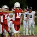Benilde-St. Margaret's quarterback Nick Peterson (18) and receiver Dylan Rash (9) celebrate their 21-7 win over Orono Friday, Aug. 30, 2019, at Benild