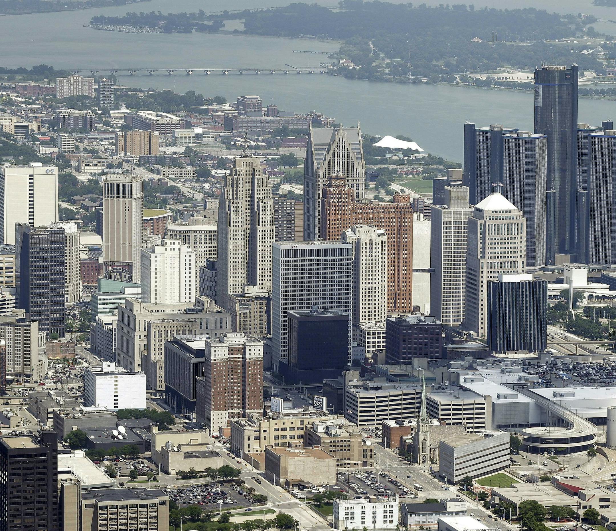 In this July 17, 2013, aerial photo is the city of Detroit. On Thursday, July 18, 2013, Detroit became the largest city in U.S. history to file for bankruptcy when State-appointed emergency manager Kevyn Orr asked a federal judge for municipal bankruptcy protection. (AP Photo/Paul Sancya) ORG XMIT: MIN2013071819214117