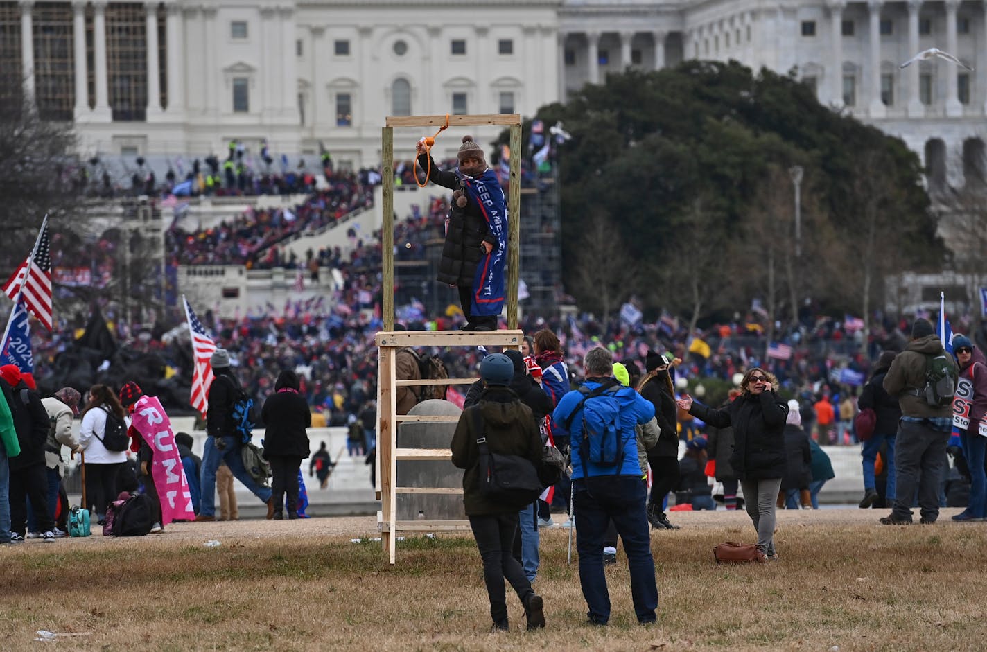 A Trump supporter poses for a photo on a makeshift gallows with a noose at the U.S. Capitol on Jan. 6, 2021 in Washington, MUST CREDIT: Washington Post photo by Ricky Carioti