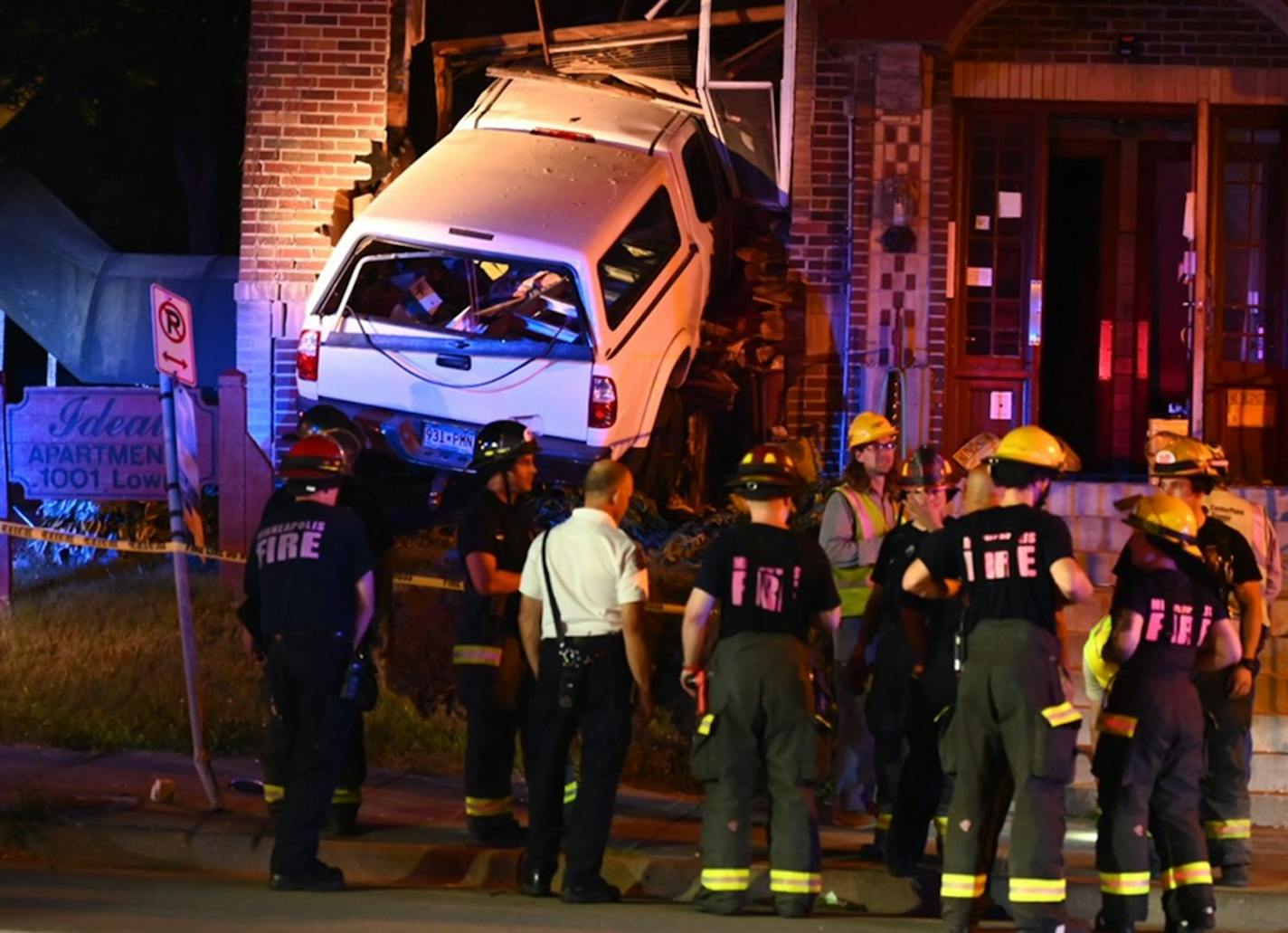 A vehicle slammed into a building Friday night near N. Lowry and Colfax avenues in Minneapolis, leaving 12 people with minor injuries, police said.