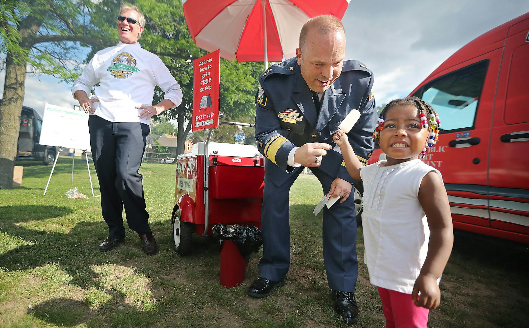 Mayor Chris Coleman laughed as he watched new St. Paul Police Chief Todd Axtell make children happy including Demeliah Britton, 2, cq, as they handed out popsicles at a Safe Summer Nights event at Arlington Hills Community Center during his first day on the job, Thursday, June 23, 2016 in St. Paul, MN. Britton was there with her grandmother Denise Harris. ] (ELIZABETH FLORES/STAR TRIBUNE) ELIZABETH FLORES • eflores@startribune.com