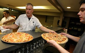 Black Sheep chef/owner Jordan Smith serves up some pizza in January 2008. The first Black Sheep shop, which opened that same year, is the only open lo