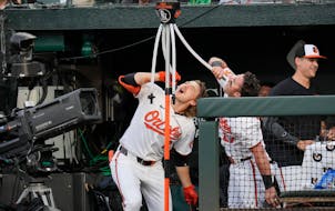 Gunnar Henderson (2) and James McCann (27) celebrated Henderson's booming home run in the second inning by drinking from the Orioles' "Homer Hydration