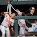 Gunnar Henderson (2) and James McCann (27) celebrated Henderson's booming home run in the second inning by drinking from the Orioles' "Homer Hydration
