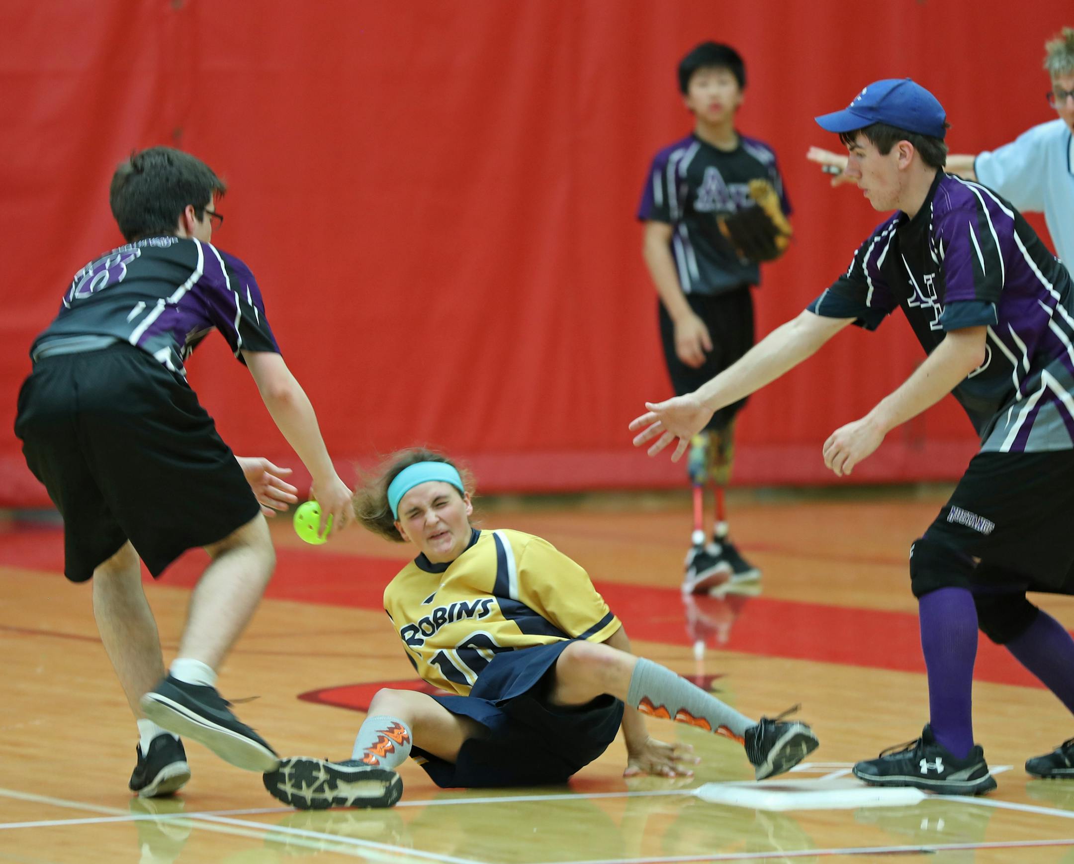 Robins base runner Hayley Engebretsen fell to the ground as Anoka-Hennepin's Tyler Ezell (left) and Joey Manion made the defensive play. Engebretsen was safe. ] Shari L. Gross ï sgross@startribune.com Championship games for the Minnesota State High School adapted softball tournament were held inside Coon Rapids High School in Coon Rapids, Minn. on Saturday, June 3, 2017. Robbinsdale/Hopkins/Mound Westonka topped Anoka-Hennepin 10-7 in the PI division, and St. Cloud Area beat Burnsville/Farm