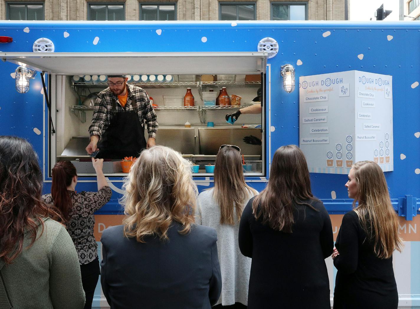 Patrons stood in line for the Dough Dough food truck Wednesday in downtown Minneapolis. ] ANTHONY SOUFFLE &#xef; anthony.souffle@startribune.com Dough Dough food truck has become a craze, drawing long lines as it sat parked Wednesday, May 24, 2017 in downtown Minneapolis.